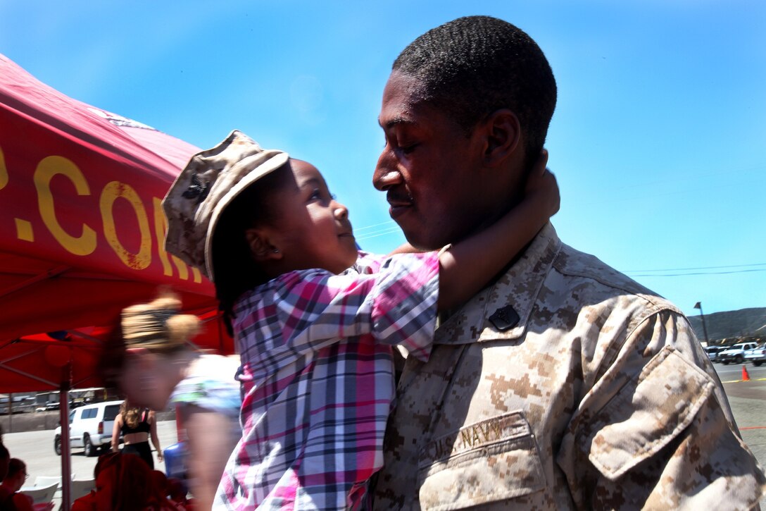 Petty Officer 3rd Class Roderick Shanks, a corpsman with Combat Logistics Battalion 15, 1st Marine Logistics Group, holds his daughter during CLB-15’s homecoming aboard Camp Pendleton, Calif., May 13, 2013. Several Marines and sailors returned from an eight-month deployment with the 15th Marine Expeditionary Unit. 