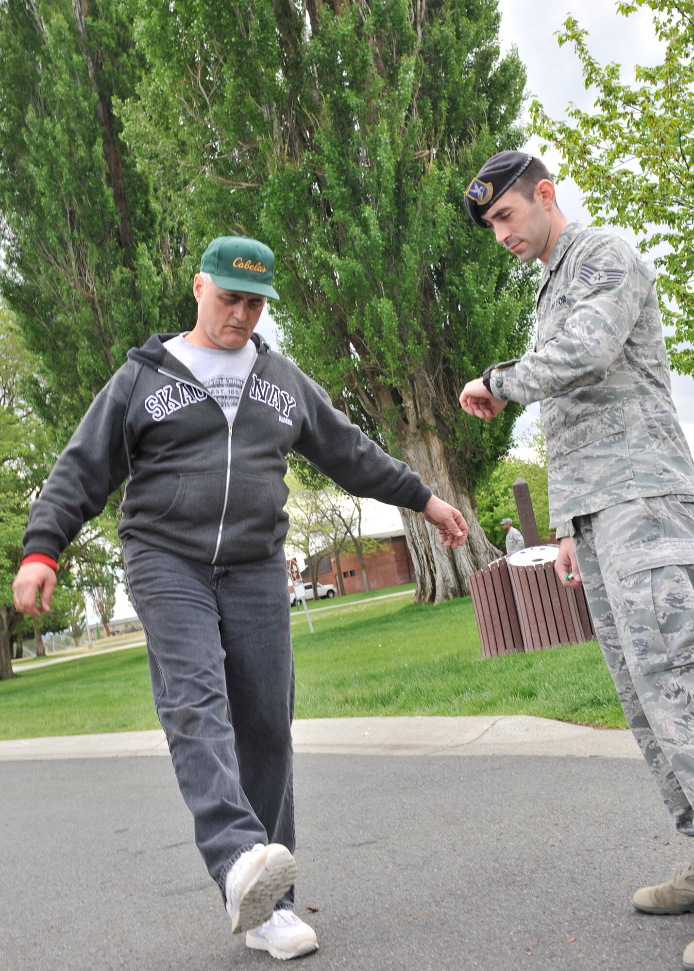 Lt. Cmdr. Kenneth Simmet, 92nd Medical Operations Squadron Mental Health Flight deputy commander, performs a field sobriety test administered by Staff Sgt. James Terry, 92nd Security Forces Squadron installation patrolman, during a simulated driving under the influence demonstration at Fairchild Air Force Base, Wash., May 16, 2013. (U.S. Air Force photo by Staff Sgt. Michael Means/Released)