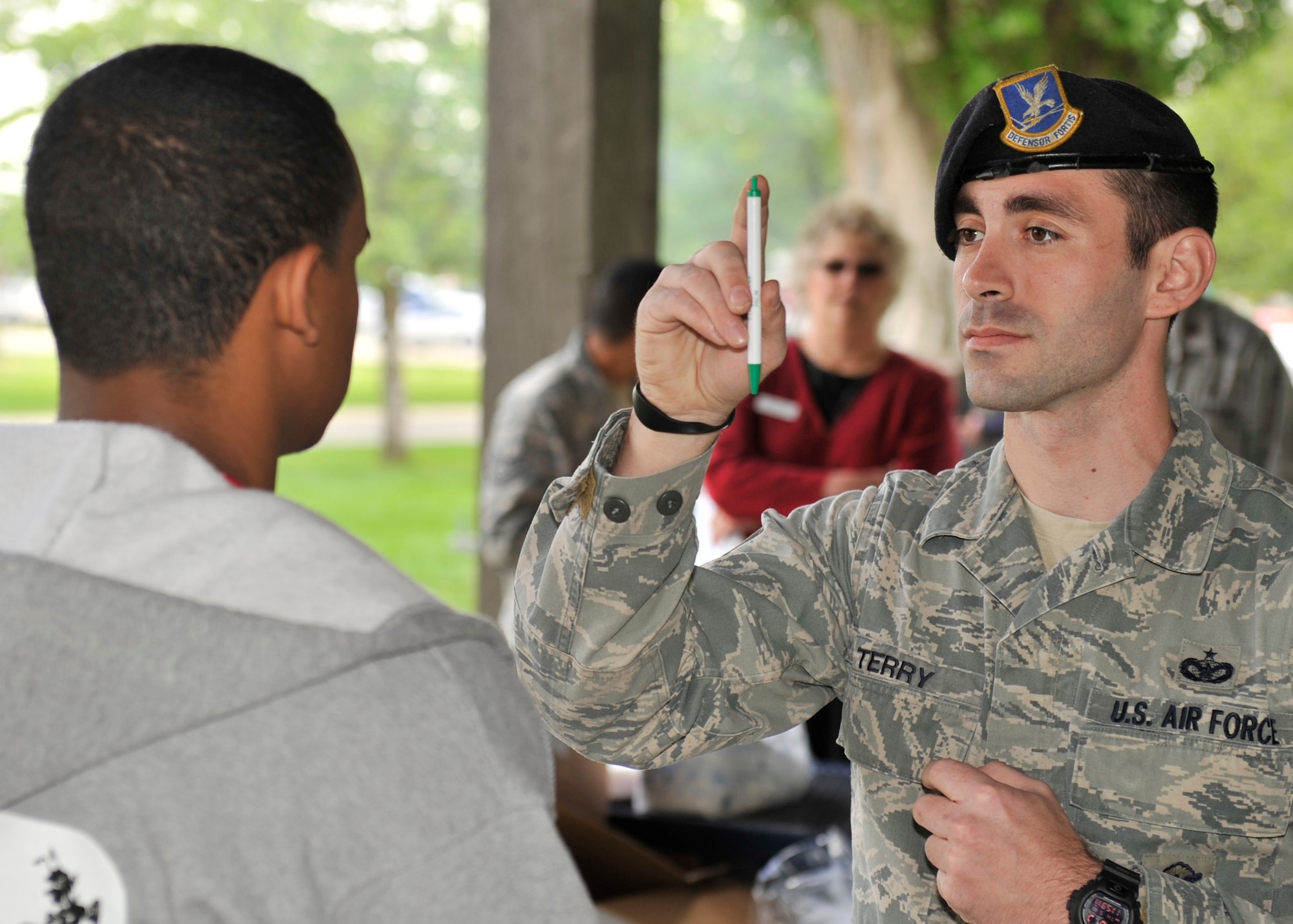 Staff Sgt. James Terry, 92nd Security Forces Squadron installation patrolman, demonstrates a field sobriety test and explains the effects alcohol has on the body and what they look for at Fairchild Air Force Base, Wash., May 16, 2013. (U.S. Air Force photo by Staff Sgt. Michael Means/Released)