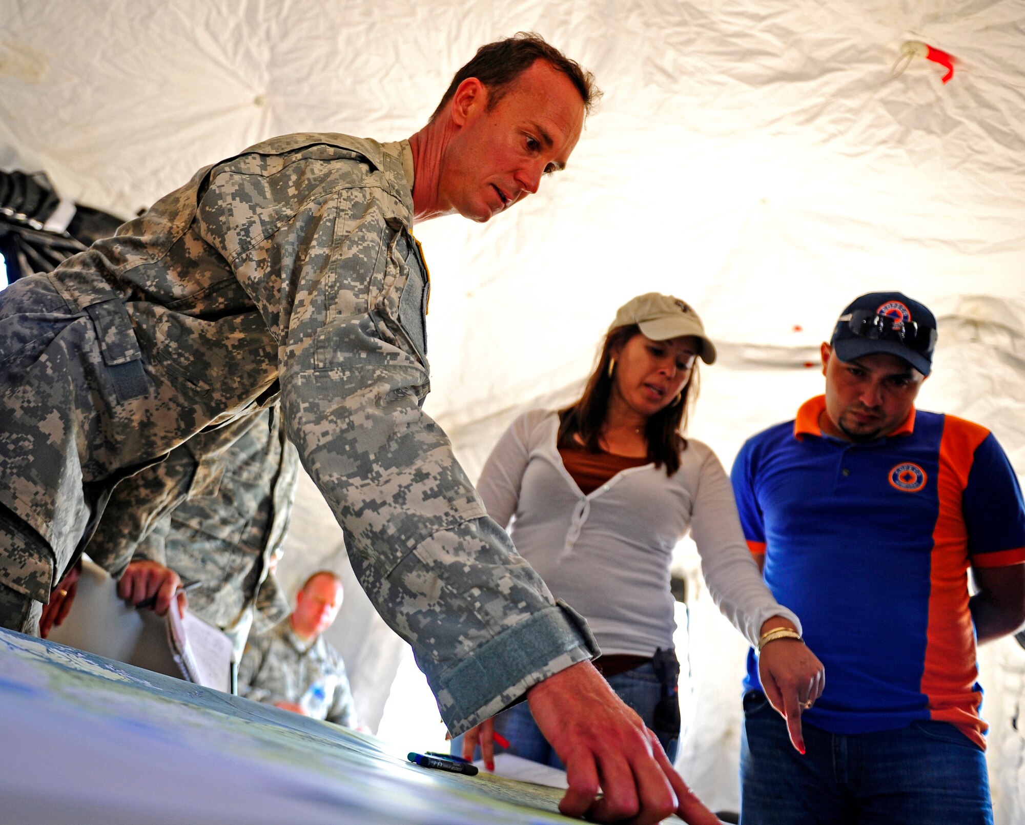United States Army Chief Warrant Officer Edmond Bessette, CENTAM Survey and Assessment Team member and Iris Medina, C-SAT member identify the location of damage for a simulated hurricane with a Honduran Comision Permanente de Contingencias member, during a simulated Hurricane disaster response exercise at Puerto Castilla, Honduras, May 15. The C-SAT team responds to a natural disaster and humanitarian assistance notification in the Central America Region to conduct an assessment of the area before military forces are deployed.(Air Force photo by Staff Sgt. Eric Donner)