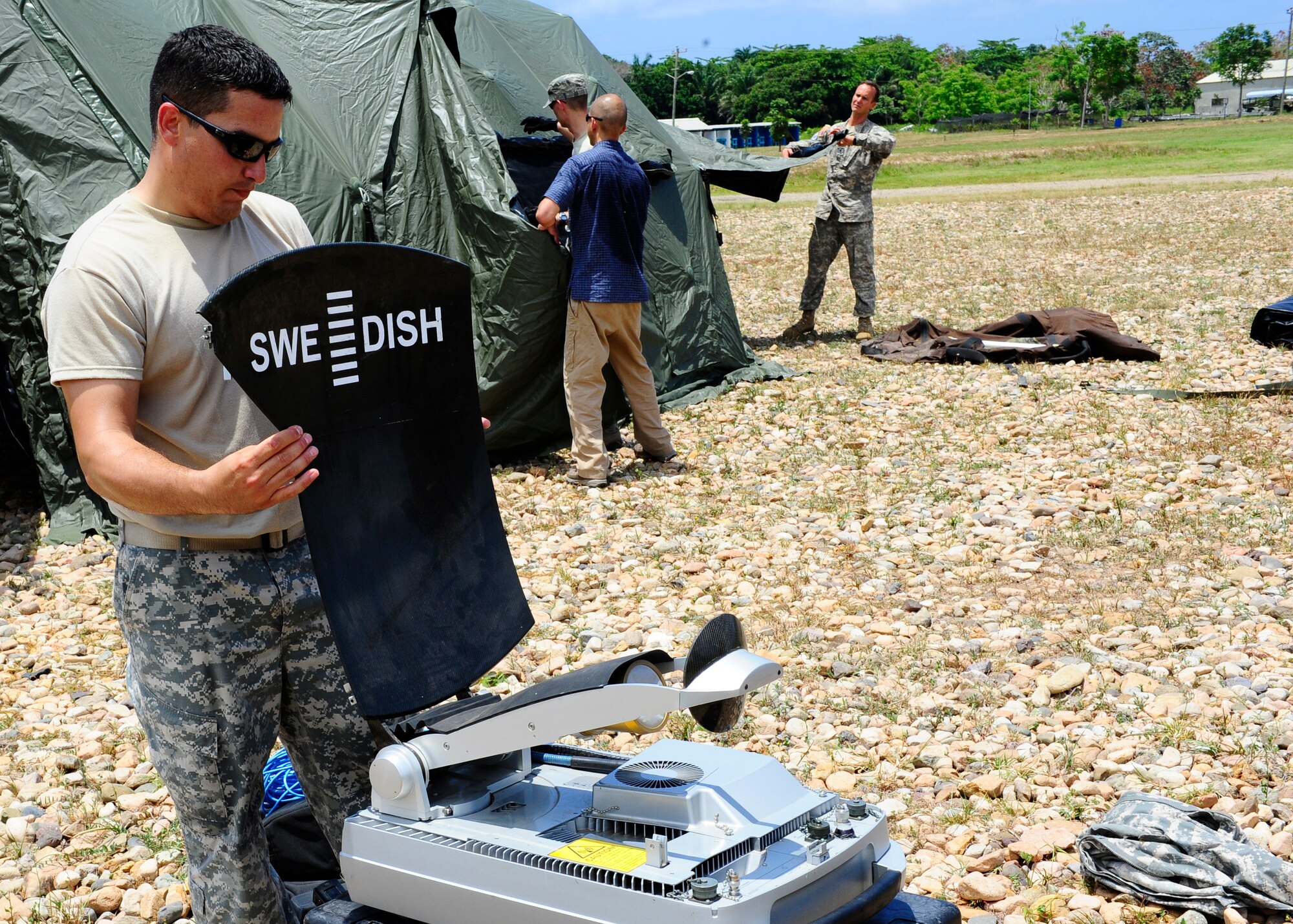 United States Army Staff Sgt. Frank Morales, CENTAM Survey and Assessment Team member, assembles a communication dish during a simulated Hurricane disaster response exercise at Puerto Castilla Honduras, May 15. The C-SAT team responds to a natural disaster and humanitarian assistance notification in the Central America Region to conduct an assessment of the area before military forces are deployed. (Air Force photo by Staff Sgt. Eric Donner)