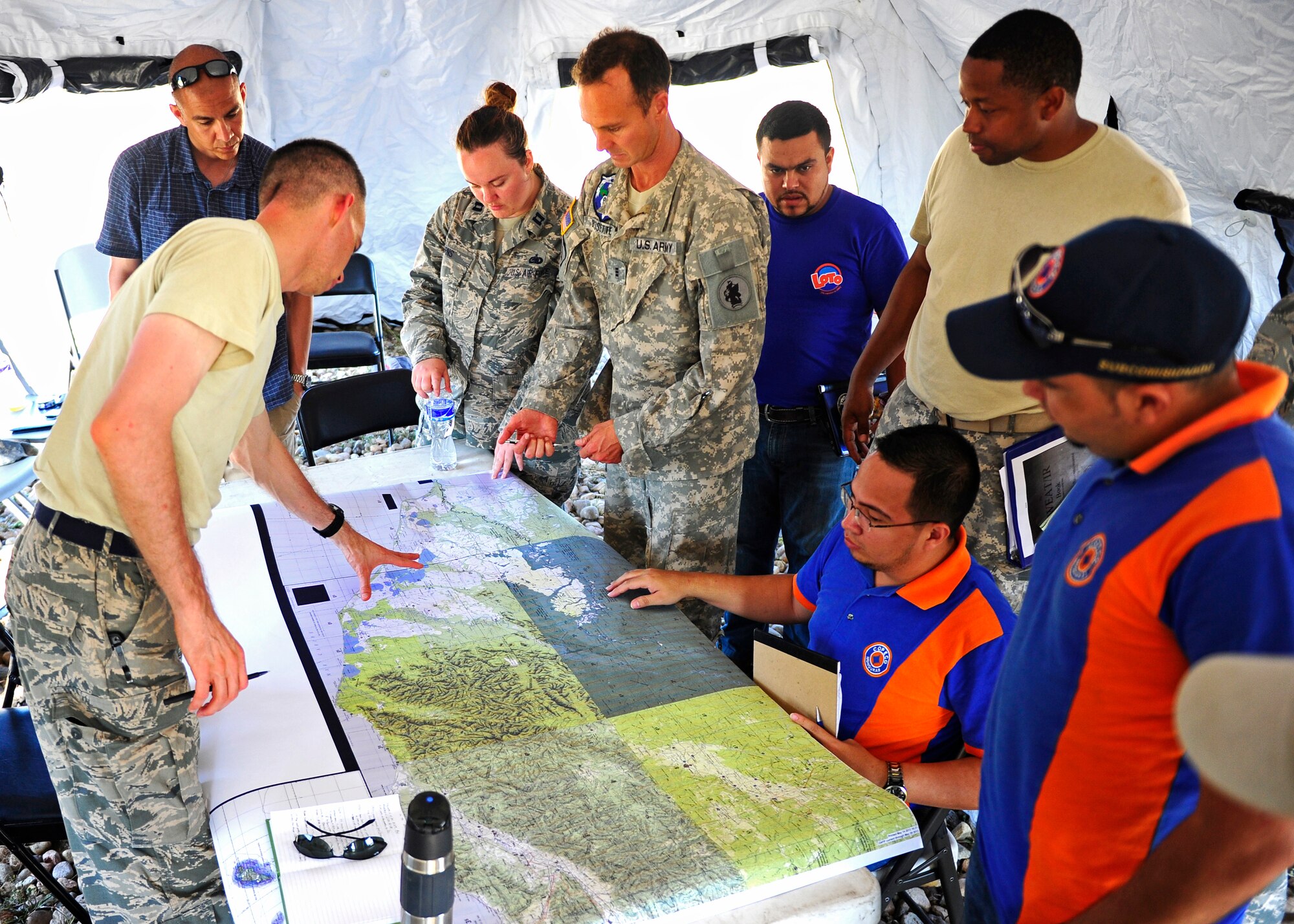 The CENTAM Survey and Assessment Team and the Honduran Comision Permanente de Contingencias look over a map of the affected area during a simulated hurricane disaster response exercise at Puerto Castilla, Honduras, May 15. The C-SAT team responds to a natural disaster and humanitarian assistance notification in the Central America Region to conduct an assessment of the area before military forces are deployed.(Air Force photo by Staff Sgt. Eric Donner)