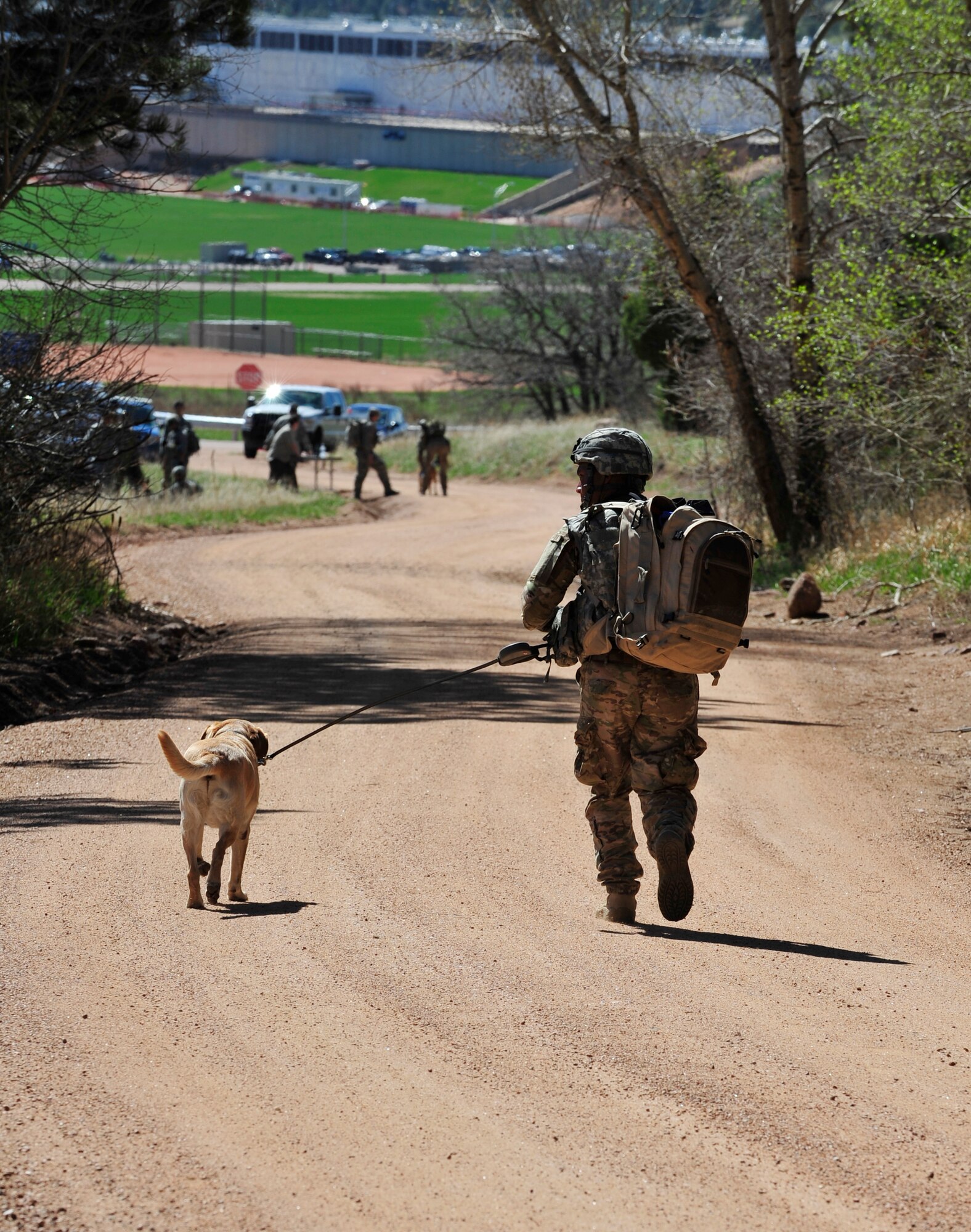 Staff Sgt. Marque Daniels, 460th Security Forces Squadron military working dog handler, and his K-9, Pierre, head toward the finish line at the Iron Dog Competition May 16, 2013, at the U.S. Air Force Academy, Colo. There were 13 teams from the Academy, Peterson Air Force Base, Colo., Buckley AFB, Colo. and F. E. Warren AFB, Wyo. The stations were set up not only challenge the physical stamina of the team but the mental stamina as well. (U.S. Air Force photo by Airman 1st Class Darryl Bolden Jr./Released)