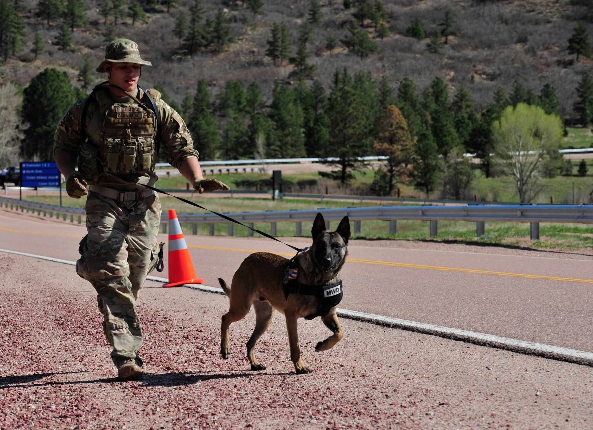 Senior Airman Joshua Carabajal, 460th Security Forces Squadron military working dog handler, competes in the Iron Dog Competition May 16, 2013, at the U.S. Air Force Academy, Colo. The competition was set up to honor all of the fallen K-9 handlers and their dogs. Dog handlers ran in battle rattle while conquering obstacles such as medical care for canine companion, tactical movement and dummy drags. (U.S. Air Force photo by Airman 1st Class Darryl Bolden Jr./Released)