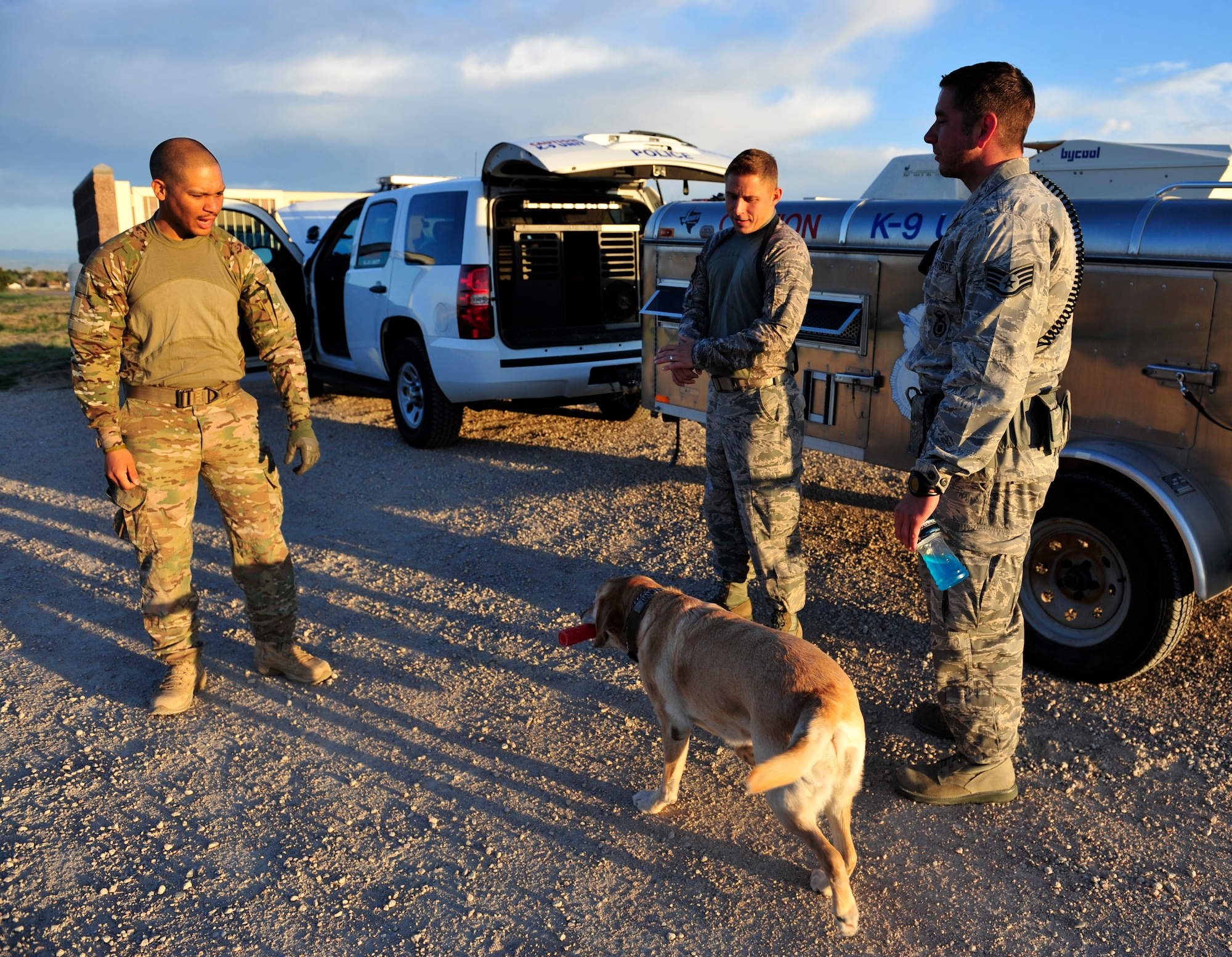 Staff Sgt. Marque Daniels, left, Staff Sgt Joshua Reid, middle and Staff Sgt Michael Clark, 460th Security Forces Squadron military working dog handlers, discuss and prepare for the upcoming Iron Dog Competition May 16, 2013, at the U.S. Air Force Academy, Colo. Several K-9 handlers from the Academy, Peterson Air Force Base, Colo., Buckley AFB, Colo., and F. E. Warren Air Force Base, Wyo. participated in the competition.  (U.S. Air Force photo by Airman 1st Class Darryl Bolden Jr./Released)