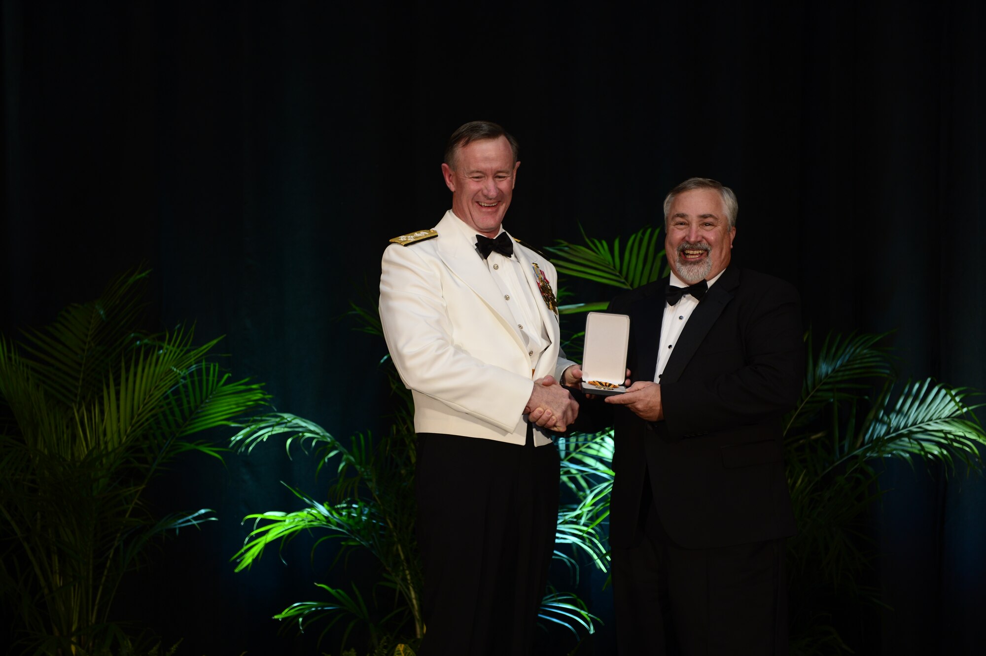 Adm. William H. McRaven, commander U.S. Special Operations Command, inducts retired Master Sgt. Scott Fales  into the Commando Hall of Honor at the 2013 Special Operations Forces Industry Conference gala dinner in Tampa, Fla., 15 May, 2013. Fales, a pararescuemen, earned the Silver Star and Purple Heart for his heroic actions during a search and rescue mission in Mogadishu, Somalia in August 1993 when Black Hawk helicopter “Super 6-1” went down. (Photos by Tech. Sgt. Angelita M. Lawrence /Released) 
  