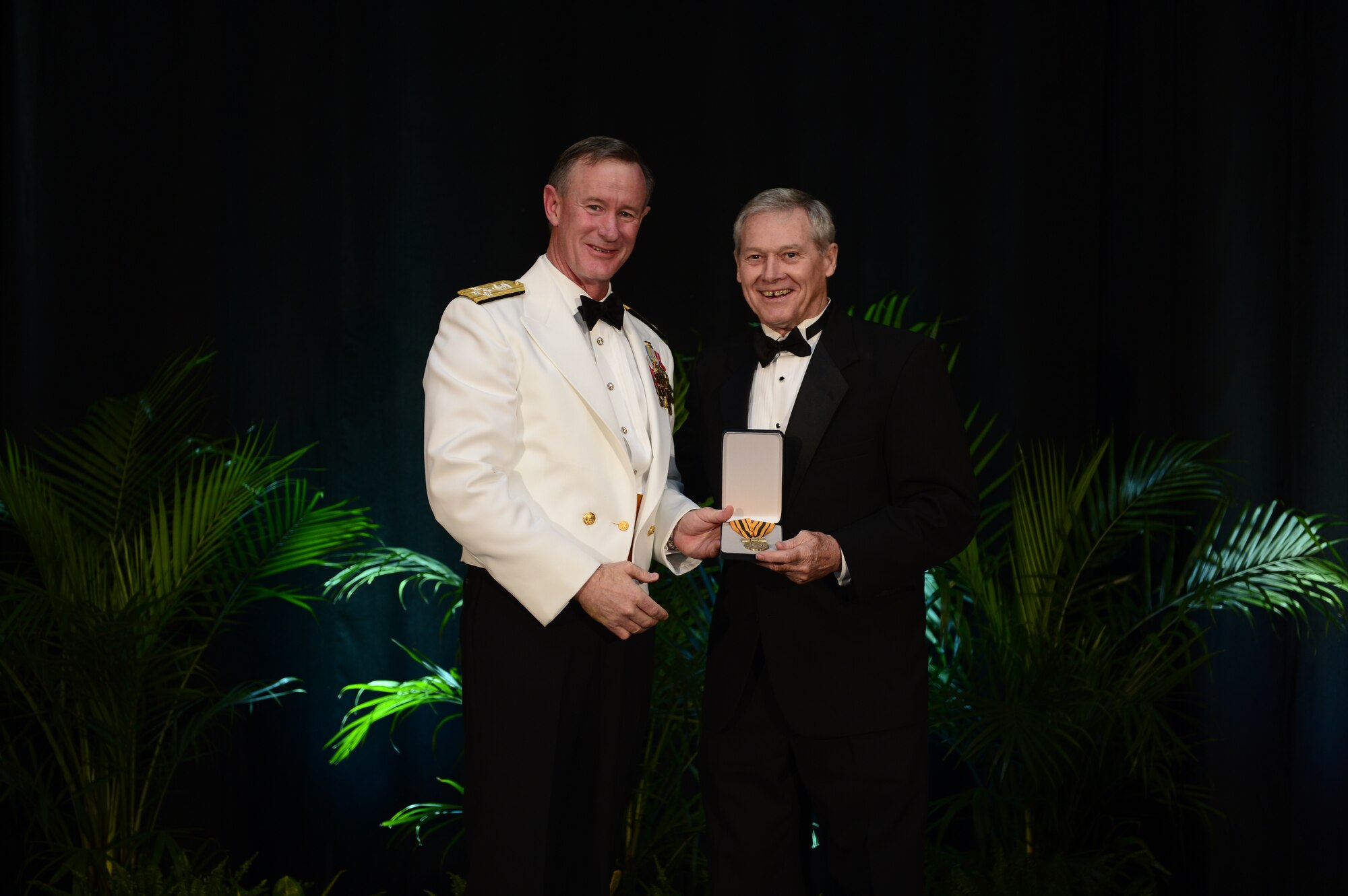 Adm. William H. McRaven, commander U.S. Special Operations Command, inducts retired Chief Master Sgt. Wayne Norrad into the Commando Hall of Honor at the 2013 Special Operations Forces Industry Conference gala dinner in Tampa, Fla., 15 May, 2013. A former Air Force Special Operations Command combat controller and command chief, Norrad was recognized for more than 45 years of service to the special operations community. (Photos by Tech. Sgt. Angelita M. Lawrence /Released) 
  