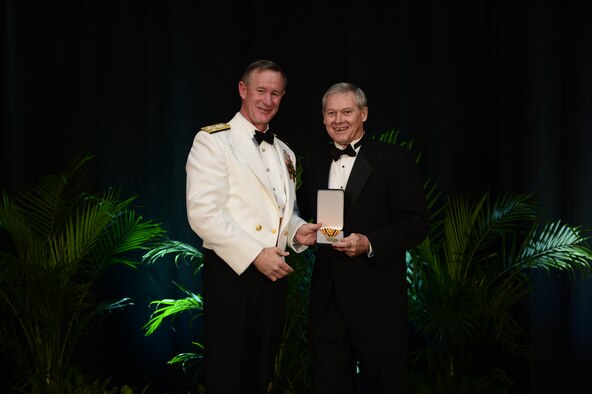 Adm. William H. McRaven, commander U.S. Special Operations Command, inducts retired Chief Master Sgt. Wayne Norrad into the Commando Hall of Honor at the 2013 Special Operations Forces Industry Conference gala dinner in Tampa, Fla., 15 May, 2013. A former Air Force Special Operations Command combat controller and command chief, Norrad was recognized for more than 45 years of service to the special operations community. (Photos by Tech. Sgt. Angelita M. Lawrence /Released) 
  