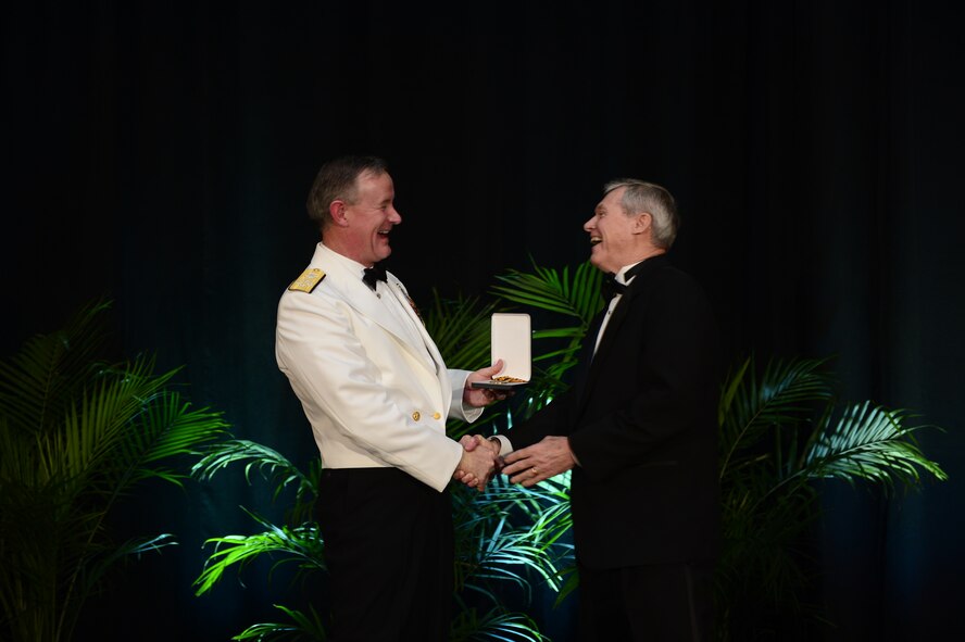 Adm. William H. McRaven, commander U.S. Special Operations Command, inducts retired Chief Master Sgt. Wayne Norrad into the Commando Hall of Honor at the 2013 Special Operations Forces Industry Conference gala dinner in Tampa, Fla., 15 May, 2013. A former Air Force Special Operations Command combat controller and command chief, Norrad was recognized for more than 45 years of service to the special operations community. (Photos by Tech. Sgt. Angelita M. Lawrence /Released) 
  