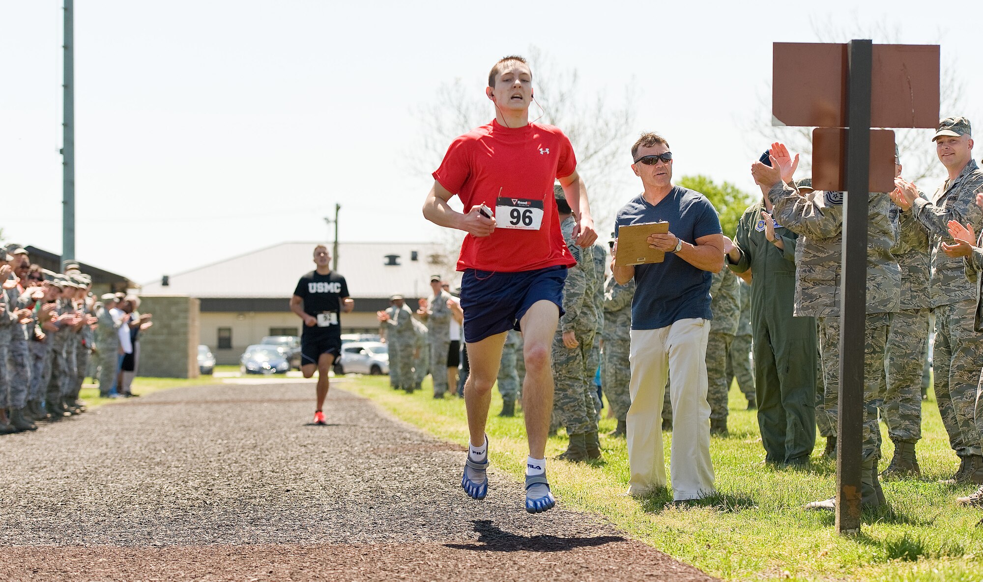 Airman 1st Class Christopher Crezee, of the 436th Aerial Port Squadron, crosses the finish line during the male Fastest Human race May 17, 2013, at Dover Air Force Base, Del.  Crezee won the one-mile race in 4 minutes, 51 seconds. (U.S. Air Force photo/Roland Balik)