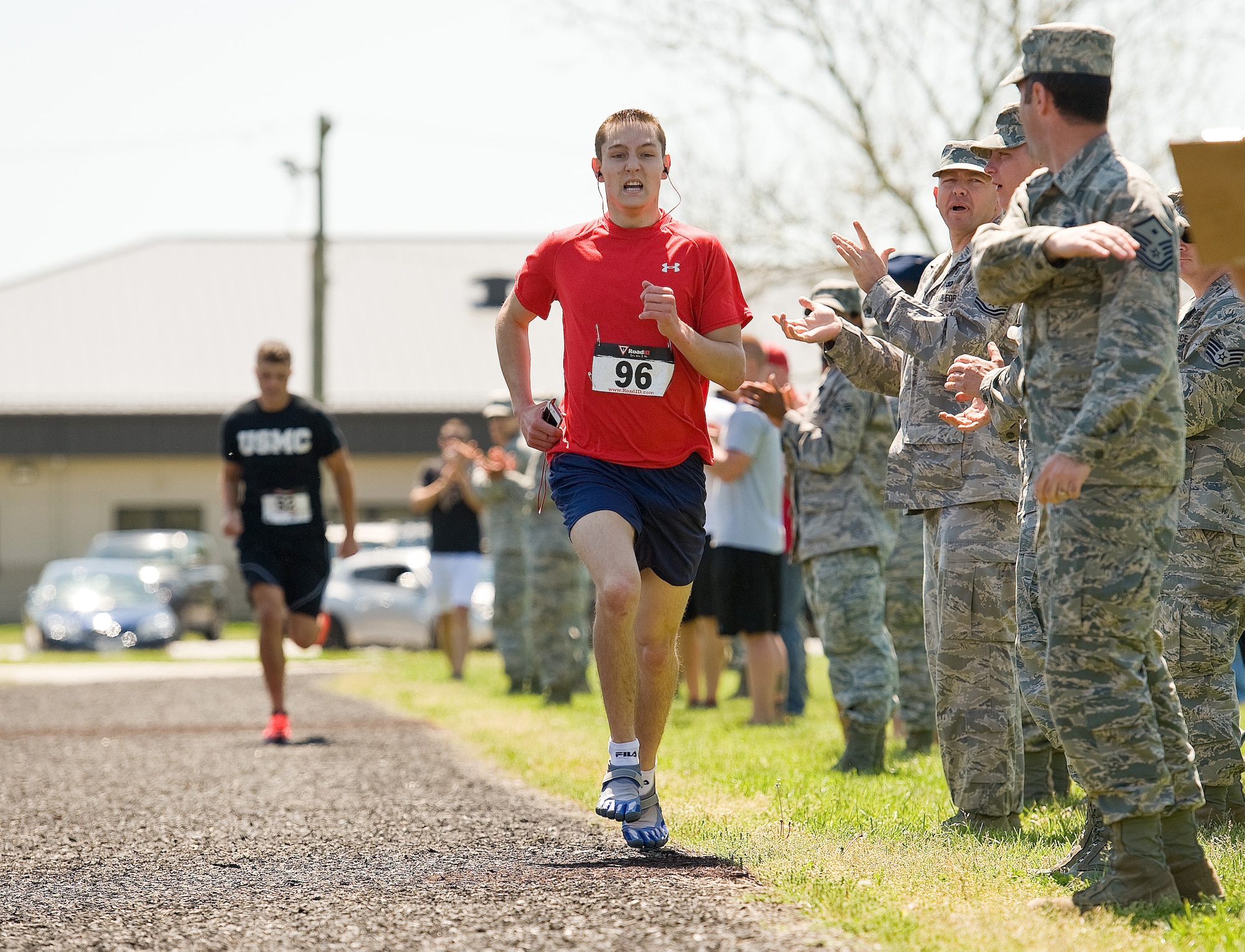 Airman 1st Class Christopher Crezee, of the 436th Aerial Port Squadron, races towards the finish line during the male Fastest Human race May 17, 2013, at Dover Air Force Base, Del.  Crezee passed U.S. Marine Sgt. Jack Sutter with a half-lap left, winning the one-mile race in 4 minutes, 51 seconds. (U.S. Air Force photo/Roland Balik)
