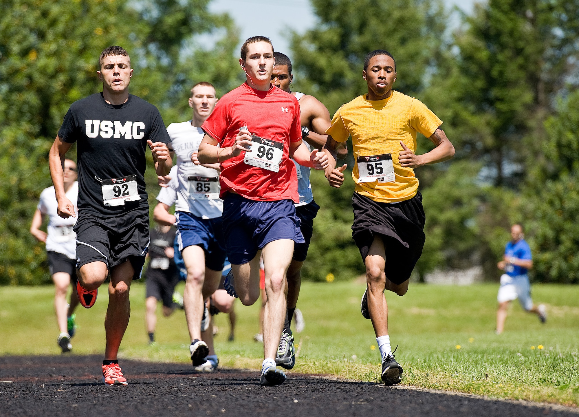 U.S. Marine Sgt. Jack Sutter, left, Joint Personal Effects Depot; Airman 1st Class Christopher Crezee, center, 436th Aerial Port Squadron; and Airman 1st Class Redmond Ellison, right, of the 436th Logistics Readiness Squadron, jockey for position during the male Fastest Human race May 17, 2013, at Dover Air Force Base, Del. Crezee won the one-mile race by passing Sutter on the last lap. Ellison finished in fourth place. (U.S. Air Force photo/Roland Balik)