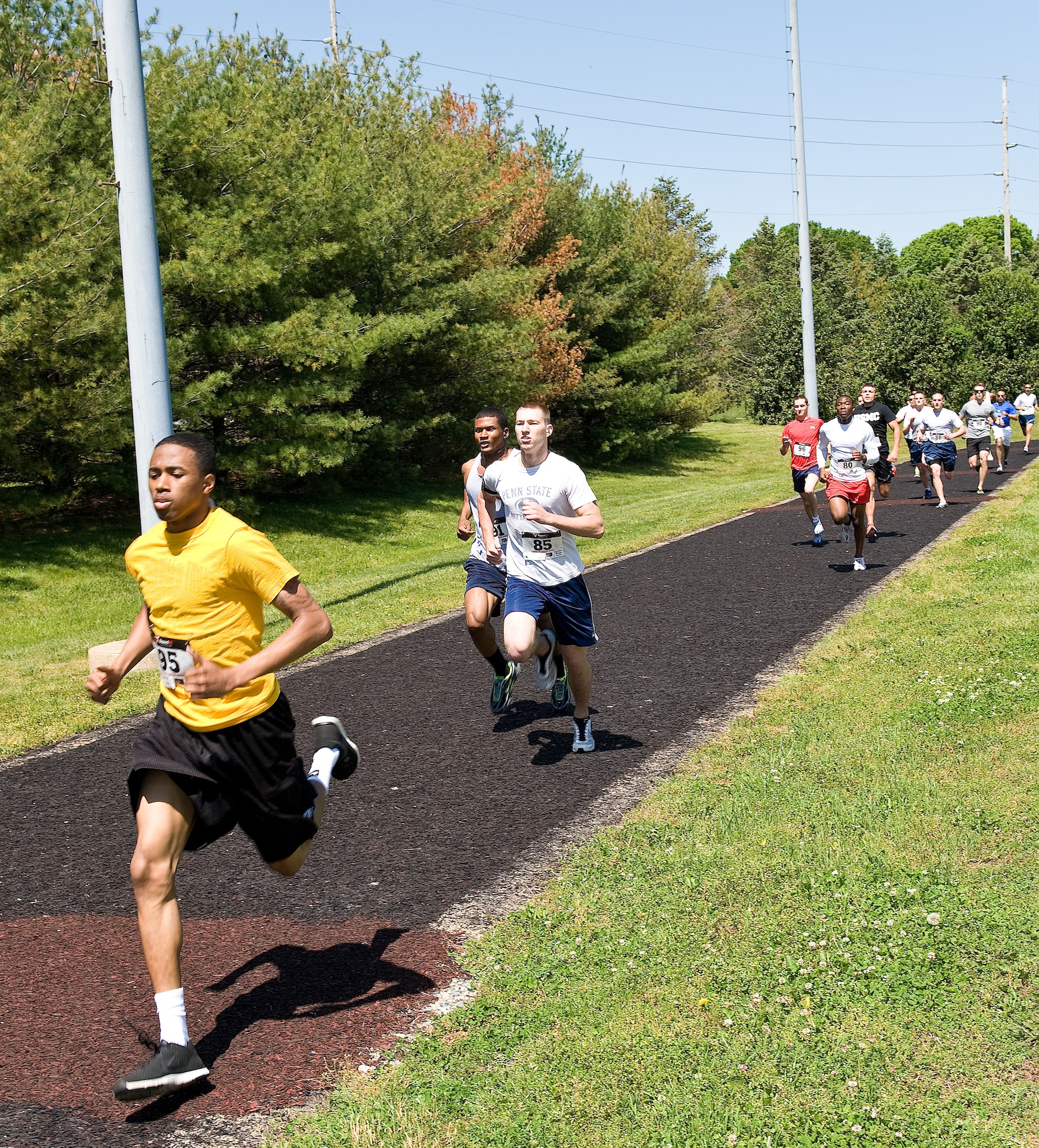 Airman 1st Class Redmond Ellison of the 436th Logistics Readiness Squadron, leads runners on the first lap of the male Fastest Human race May 17, 2013, at Dover Air Force Base, Del. Ellison led the field of 15 runners for awhile and finished the race in 5 minutes, 24 seconds. (U.S. Air Force photo/Roland Balik)
