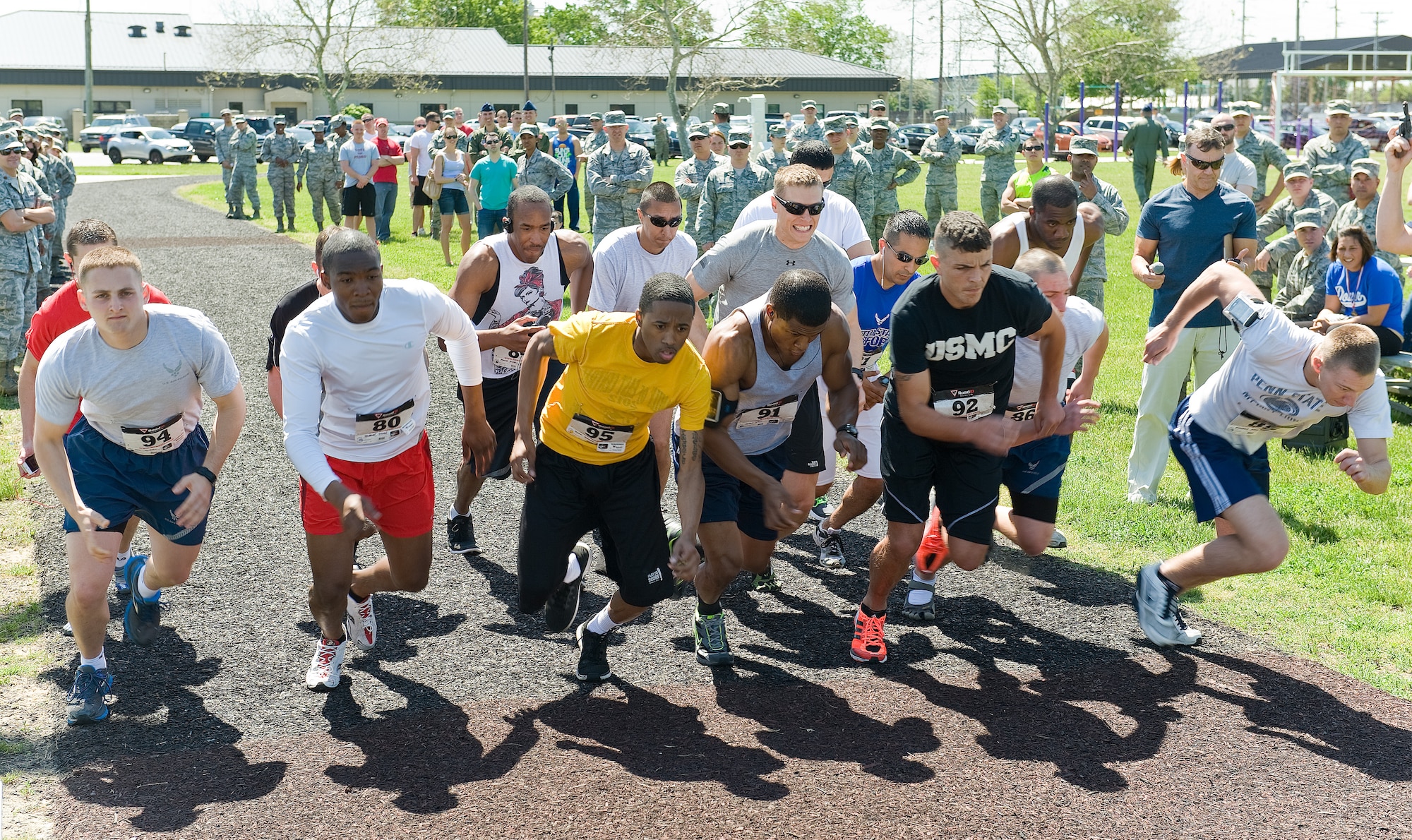Runners line up on the starting line for the male Fastest Human race May 17, 2013, at Dover Air Force Base, Del. The one-mile race was won by Airman 1st Class Christopher Crezee of the 436th Aerial Port Squadron, clocking a time of 4 minutes, 51 seconds. The DAFB Fitness Center held the event to promote fitness and camaraderie across the base. (U.S. Air Force photo/Roland Balik)