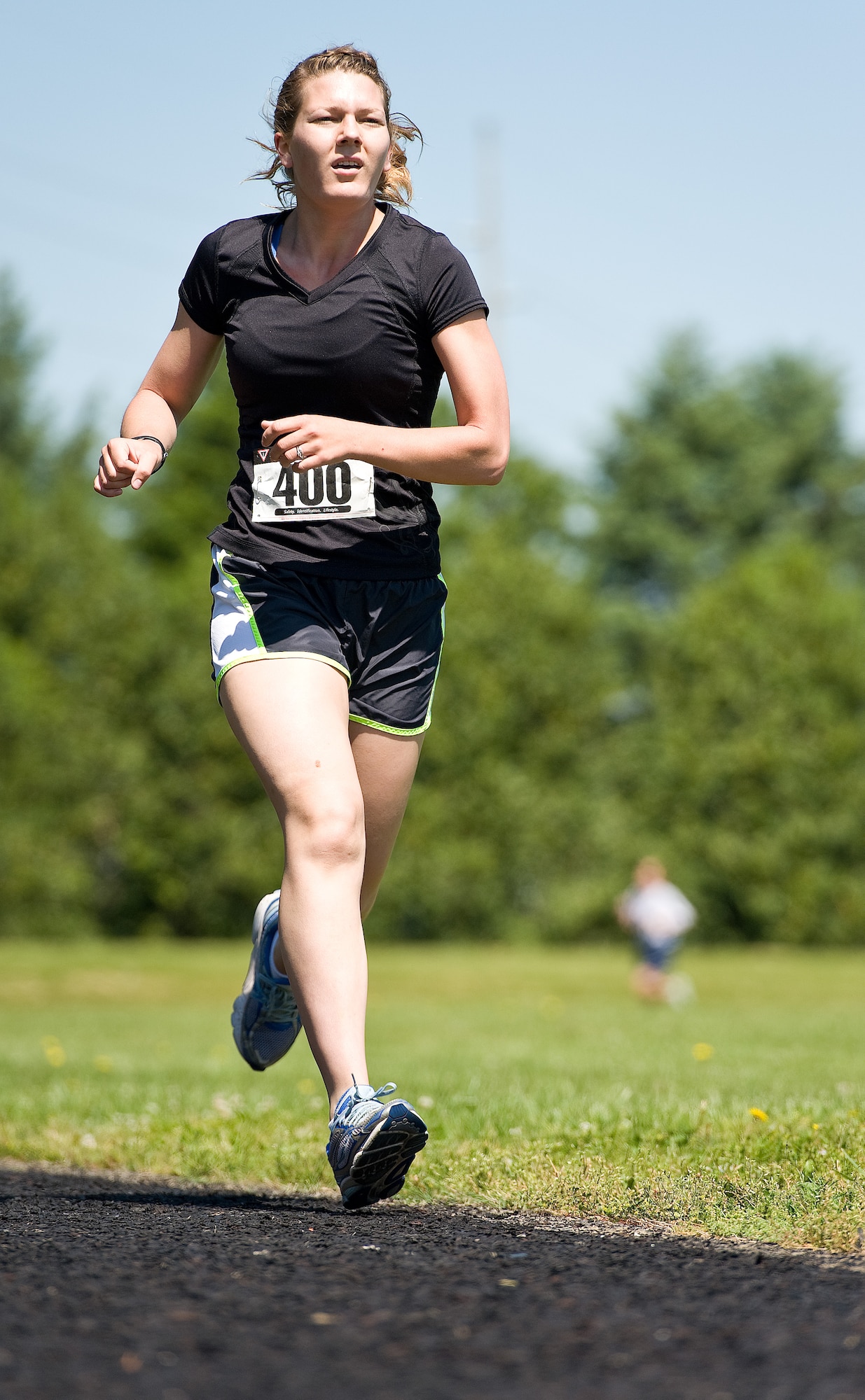Airman 1st Class Emalyn Schliesing of the 736th Aircraft Maintenance Squadron, runs in the female Fastest Human race, May 17, 2013, at Dover Air Force Base, Del. Finishing ahead of seven other runners,Schliesing won the one-mile race by recording a time of 6 minutes, 7 seconds. (U.S. Air Force photo/Roland Balik)