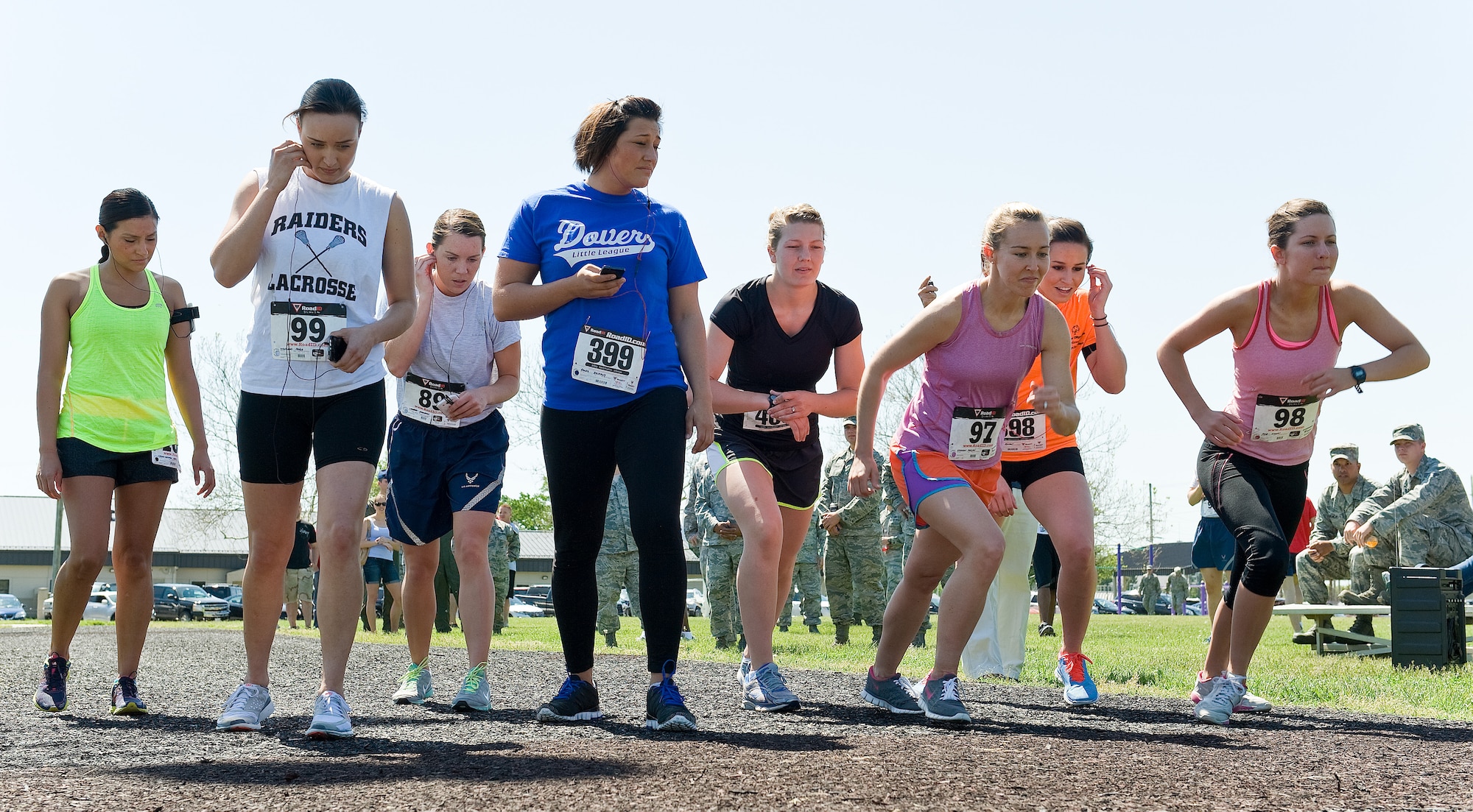 Runners line up on the starting line for the female Fastest Human race May 17, 2013, at Dover Air Force Base, Del. The one-mile race was won by Airman 1st Class Emalyn Schliesing of the 736th Aircraft Maintenance Squadron, clocking a time of 6 minutes, 7 seconds. The DAFB Fitness Center held the event to see who is the fastest human on the base for both male and females. (U.S. Air Force photo/Roland Balik)