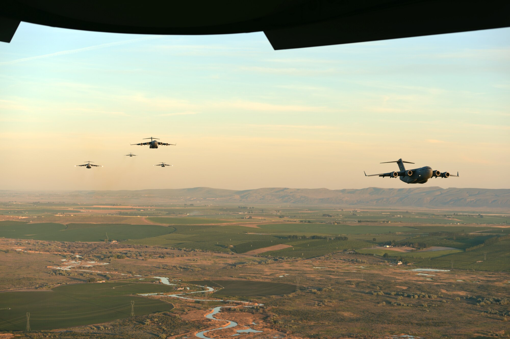Seven C-17 Globemaster III aircraft from Joint Base Lewis-McChord, Wash., fly in formation May 14, 2013 toward a drop zone east of Moses Lake, Wash. Airdrops allow the Air Force to deliver supplies to troops in remote locations as well as supply humanitarian support to other nations. (U.S. Air Force photo/Airman 1st Class Jacob Jimenez)