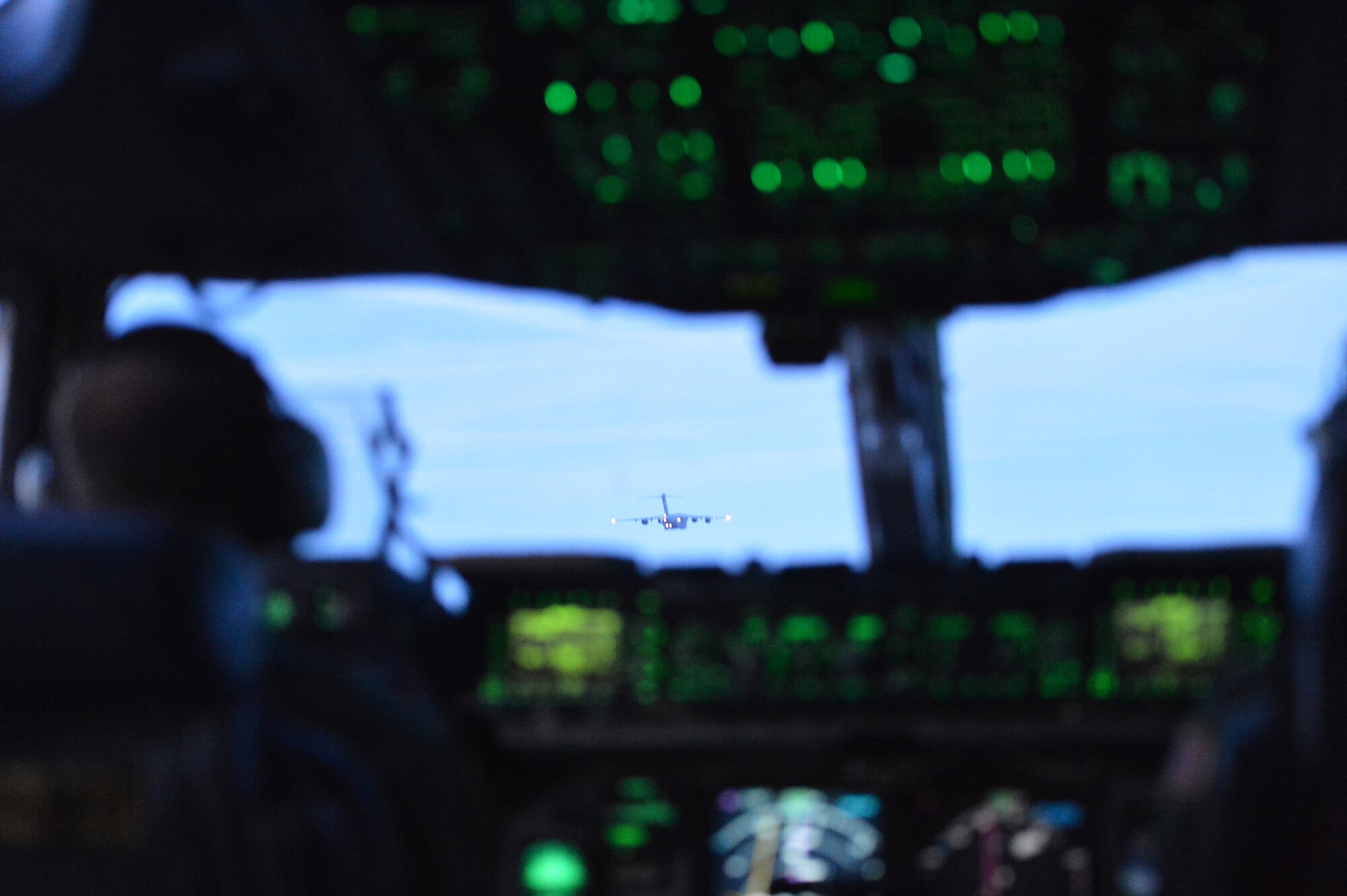 Capt. Donald Frey, 7th Airlift Squadron pilot, keeps a watchful eye on the lead C-17 Globemaster III aircraft May 14, 2013, during a 7-ship formation flight at Joint Base Lewis-McChord, Wash. The training mission incorporated numerous multi-element training scenarios. (U.S. Air Force photo/Airman 1st Class Jacob Jimenez)