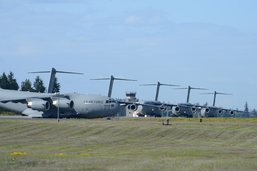 Seven C-17 Globemaster III aircraft taxi to the runway prior to takeoff May 14, 2013 at Joint Base Lewis-McChord, Wash. (U.S. Air Force photo/Staff Sgt. Frances Kriss)