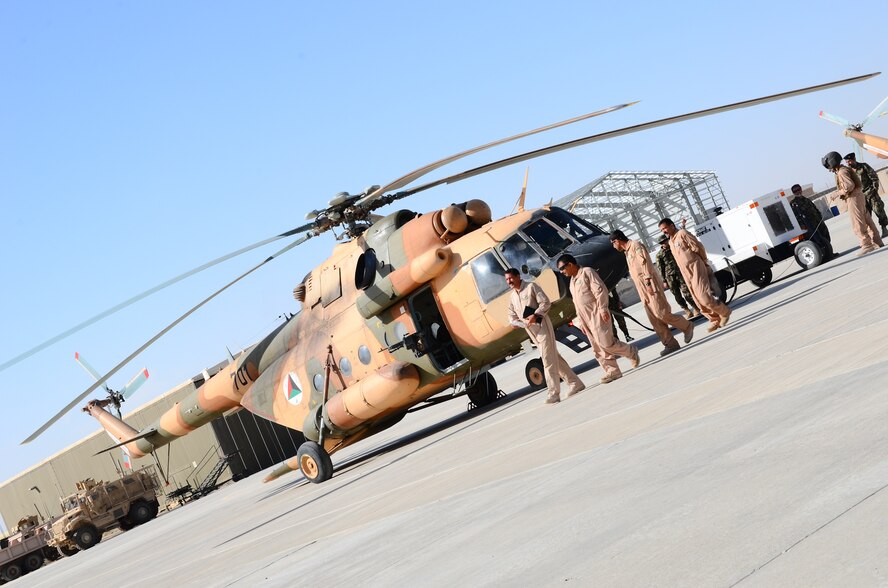 KANDAHAR, Afghanistan – A group of Afghan Air Force MI-17 helicopter maintenance personnel depart the area after completing preflight checks before a local training mission at Kandahar Airfield May 6, 2013. AAF maintainers receive English language and helicopter maintenance training courses build the AAF’s capacity to sustain their fleet in support of their mission. (U.S. Air Force photo/1st Lt Tony Richardson)