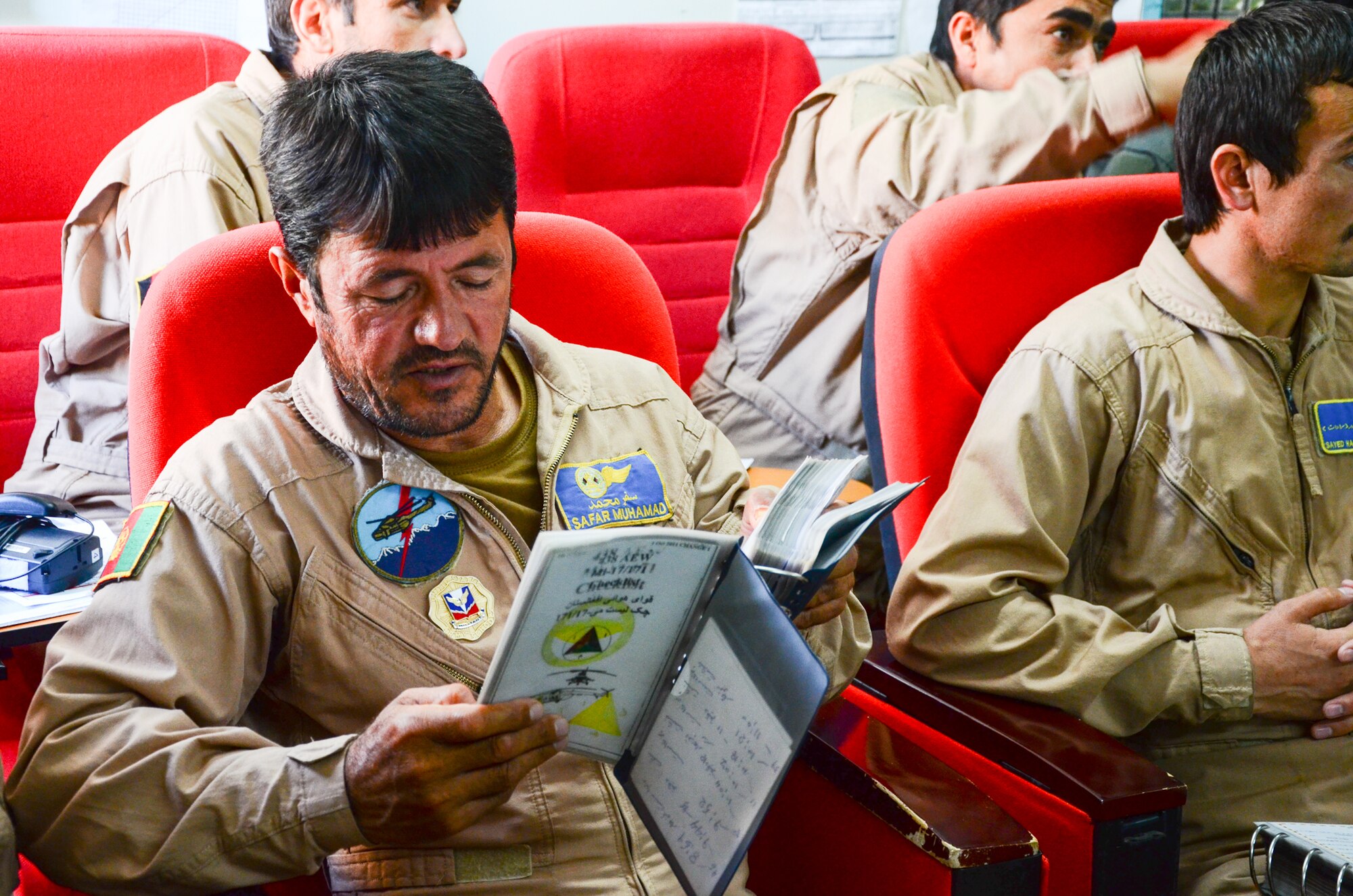 KANDAHAR, Afghanistan – Afghan Air Force Sgt. Safar Muhammad, MI-17 helicopter flight engineer, reviews emergency checklists in a flight manual during a local training mission briefing at Kandahar Airfield May 6, 2013. MI-17 crews, which consist of two pilots, one flight engineer and two aerial gunners, team with air advisors from the 441st Air Expeditionary Advisor Squadron daily to achieve the goal of Afghan-planned, led and coordinated operations by the end of 2014. (U.S. Air Force photo/1st Lt Tony Richardson)