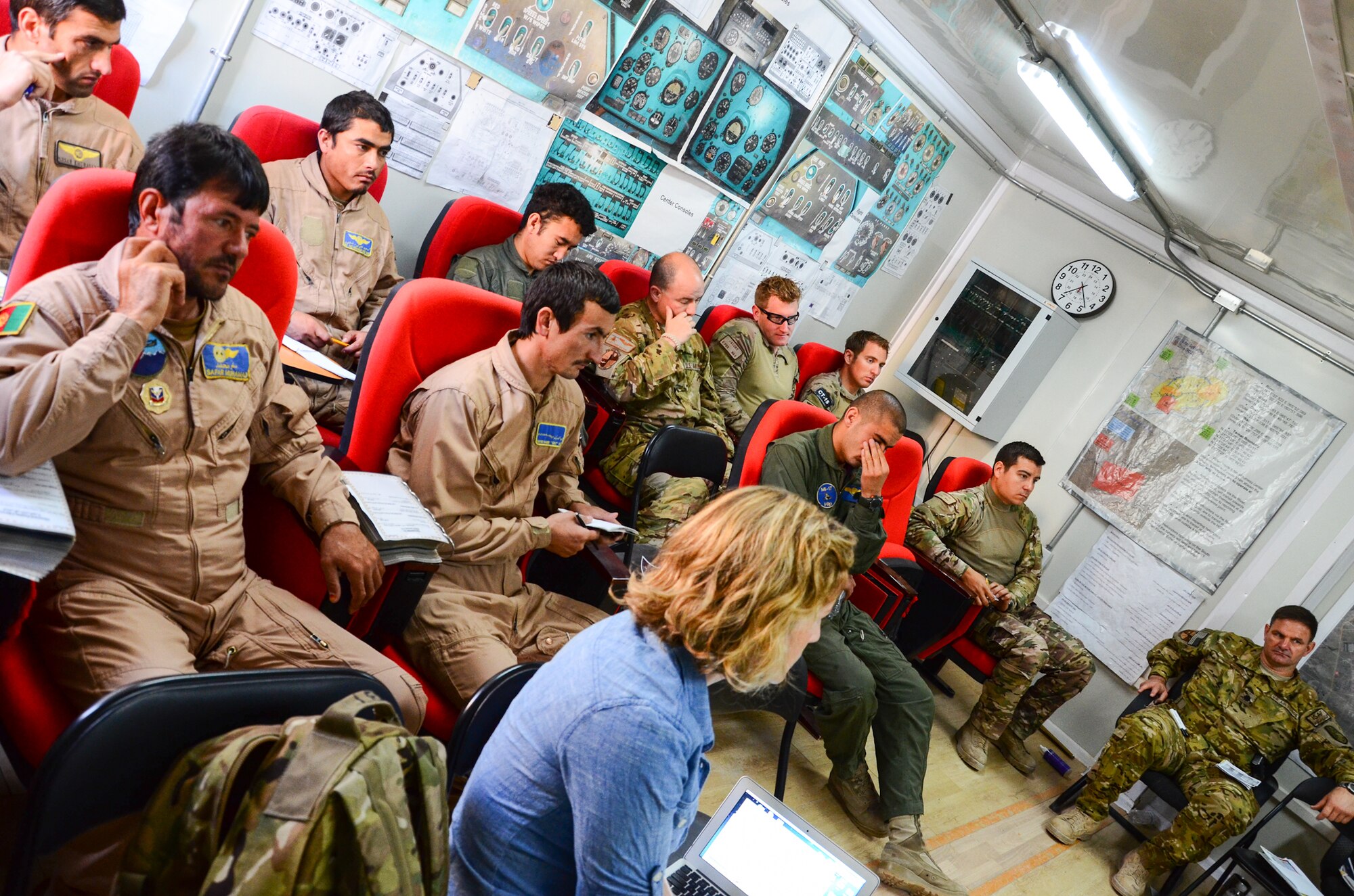 KANDAHAR, Afghanistan – Two Afghan Air Force MI-17 helicopter flight crews receive their final mission briefing prior to departing on a local training mission at Kandahar Airfield May 6, 2013. The crews, which consist of two pilots, one flight engineer and two aerial gunners, team with air advisors from the 441st Air Expeditionary Advisor Squadron daily to achieve the goal of Afghan-planned, led and coordinated operations by the end of 2014. (U.S. Air Force photo/1st Lt Tony Richardson)