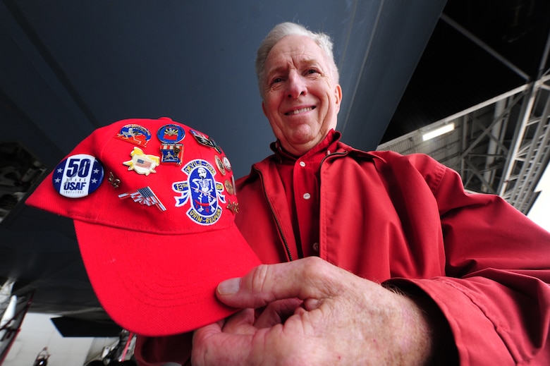 Robert Butterfield, retired 13th Bomb Squadron member, shows off the Air Force pins on his hat during a B-2 Spirit tour at Whiteman Air Force Base, Mo., May 10, 2013. As one of the original 13th Bomb Squadron members, Butterfield served more than 20 years in the Air Force. (U.S. Air Force photo by Staff Sgt. Nick Wilson/Released)