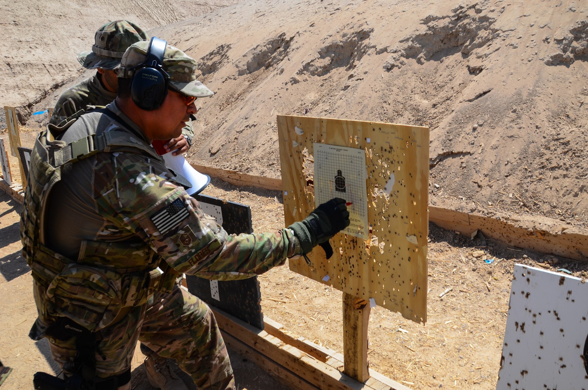 KANDAHAR, Afghanistan -- U.S. Air Force Master Sgt. Patrick Flores, 443rd Air Expeditionary Advisor Squadron security forces advisor, provides sight alignment corrections and recommendations to a group of Afghan Air Force and Afghan National Army troops during a firing range exercise at Kandahar Airfield May 6, 2013. The 443rd Air Expeditionary Advisor Squadron security forces advisors train AAF and ANA security forces daily as Afghanistan assumes primary responsibility for security in the country. (U.S. Air Force photo/1st Lt Tony Richardson)