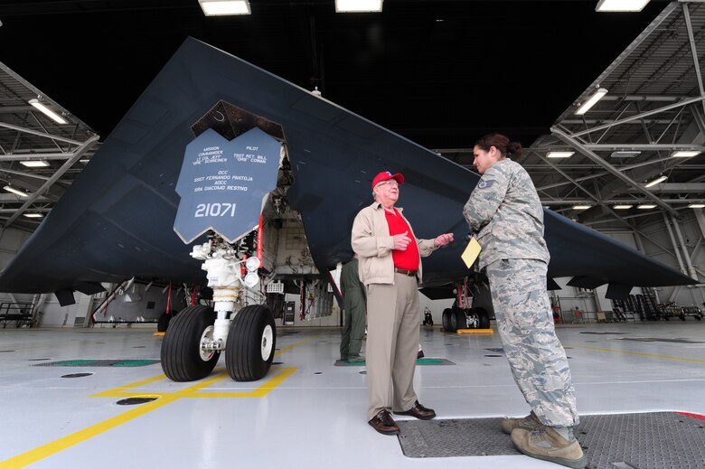 Robert Parks, retired 13th Bomb Squadron member, speaks to Staff Sgt. Leah Simpson, 13th BS security manager during a B-2 Spirit tour at Whiteman Air Force Base, Mo., May 10, 2013. Parks was one of the original 13th BS members and was on the tour as part of the annual 13th BS heritage day celebration. (U.S. Air Force photo by Staff Sgt. Nick Wilson/Released)
