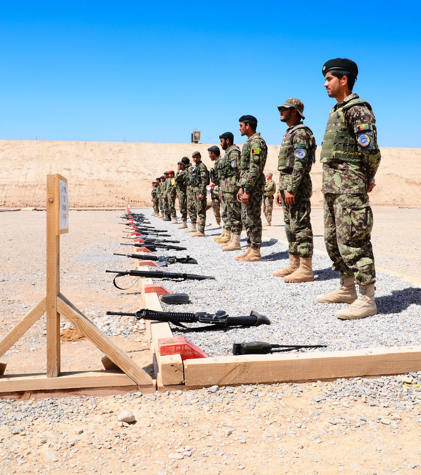 KANDAHAR, Afghanistan – Afghan National Army and Afghan Air Force security forces troops line up behind their M16A2 rifles prior to a live-fire training exercise at a firing range on Kandahar Airfield May 6, 2013. The 443rd Air Expeditionary Advisor Squadron security forces advisors train AAF and Afghan National Army security forces daily as Afghanistan assumes primary responsibility for security in the country. (U.S. Air Force photo/1st Lt Tony Richardson)