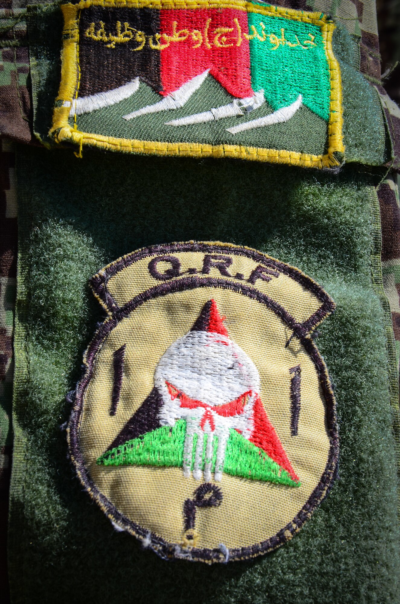 KANDAHAR, Afghanistan – An Afghan Air Force security forces member displays his  Quick Response Forces uniform patch at Kandahar Airfield May 6, 2013. QRFs are trained to rapidly respond to contingencies within their area of jurisdiction. AAF and Afghan National Army QRF units are receiving training from the 443rd Air Expeditionary Advisor Squadron as Afghanistan assumes greater responsibility for security in the country. (U.S. Air Force photo/1st Lt Tony Richardson)