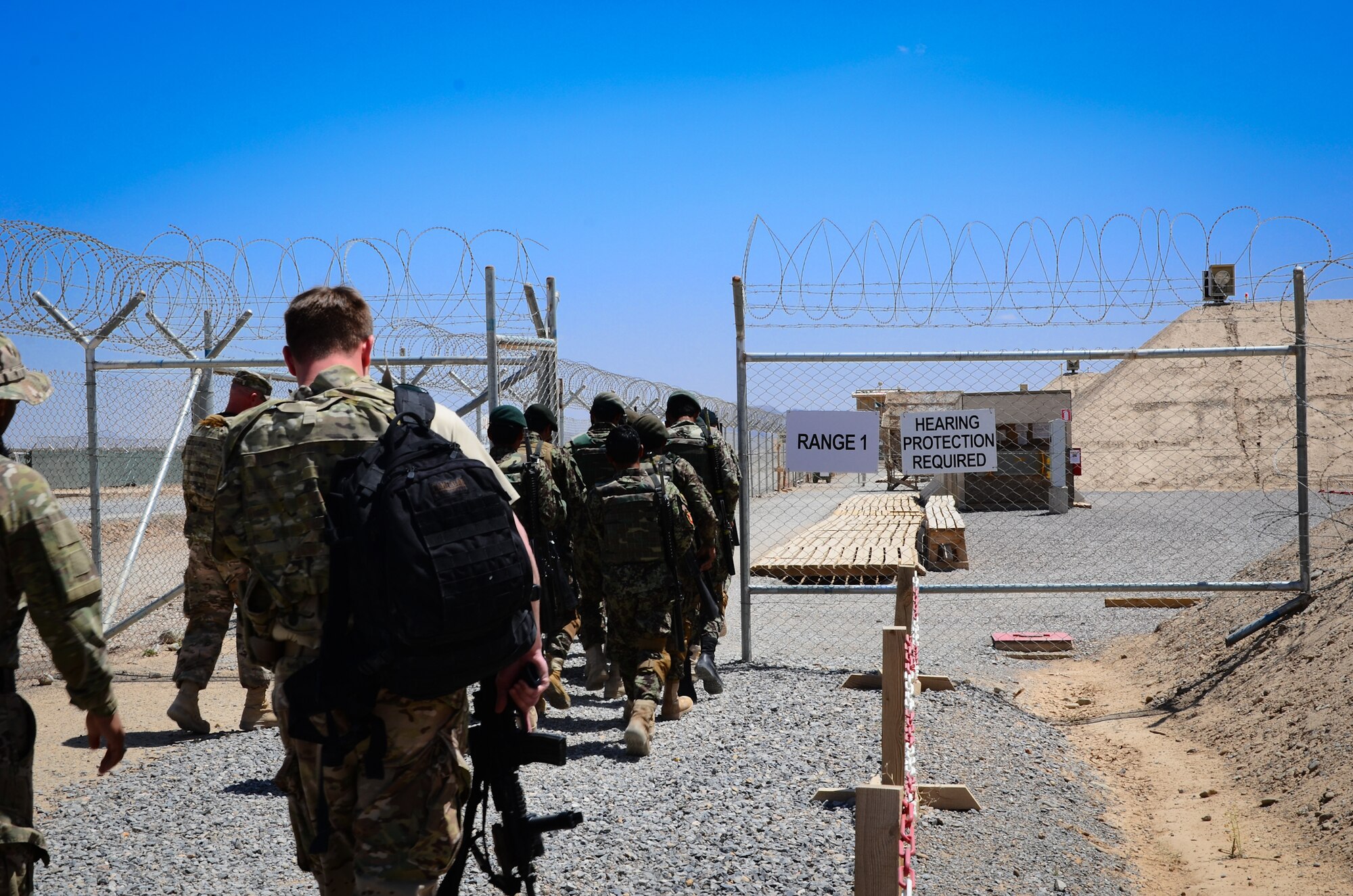 KANDAHAR, Afghanistan – Afghan National Army and Afghan Air Force security forces troops enter a live-fire training range at Kandahar Airfield May 6, 2013. The 443rd Air Expeditionary Advisor Squadron security forces advisors train the ANA and AAF security forces daily as Afghanistan assumes greater responsibility for security in the country. (U.S. Air Force photo/1st Lt Tony Richardson)