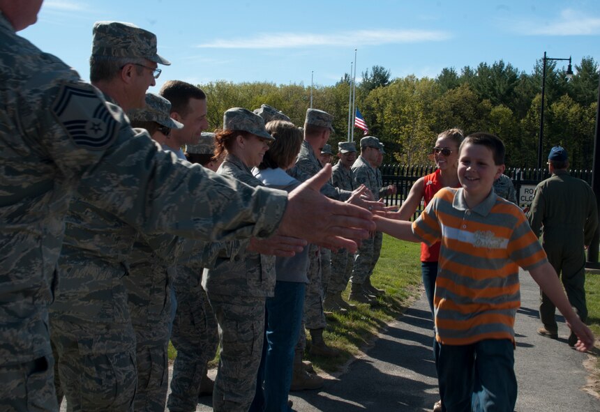 Caleb Bertrand and Megan Lyman (former Miss New Hampshire 2012) are welcomed by members of the 157th Air Refueling Wing, Pease Air National Guard Base, N.H., May 17, 2013.  11 year old Bertrand is undergoing treatment for lieukemia and is visitn Pease as part of the Make-A-Wish foundation program. (U.S. Air Natonal Guard photo by Tech. Sgt. Aaron Vezeau/Released)