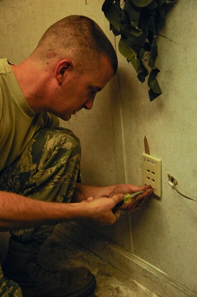 Senior Airman Michael Maner, 2nd Communications Squadron, installs a phone jack on Barksdale Air Force base, La., May 16, 2013. Communications Airmen's duties include establishing lines of communication for Barksdale and maintaining internet and phone lines. (U.S. Air Force photo/Airman 1st Class Andrew Moua)