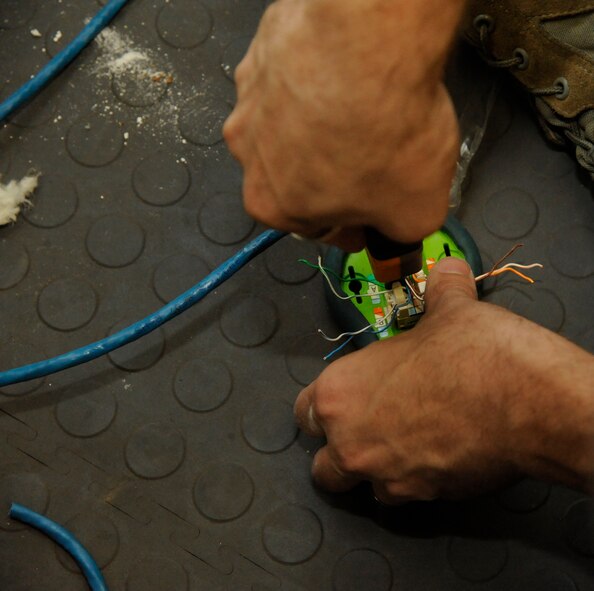 Senior Airman Michael Maner, 2nd Communications Squadron, terminates wires with a punch-down tool on Barksdale Air Force Base, La., May 16, 2013. Terminating the wires allows the cable to be accessible to its users. (U.S. Air Force photo/Airman 1st Class Andrew Moua)