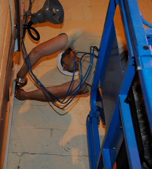 Airman 1st Class Ryan Darrow, 2nd Communications Squadron, secures Local Area Network cables on Barksdale Air Force Base, La., May 16, 2013. Communications Airmen's duties include establishing lines of communication for Barksdale and maintaining internet and phone lines. (U.S. Air Force photo/Airman 1st Class Andrew Moua)