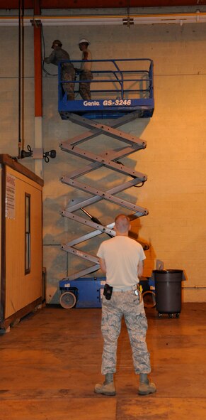 Senior Airman Michael Maner, foreground, observes Airmen 1st Class Creston Jenkins and Ryan Darrow, 2nd Communications Squadron, set up Local Area Network cables at the 2nd Logistics Readiness Squadron Shipment and Distribution Flight on Barksdale Air Force Base, La., May 16, 2013. Communications Airmen's duties include establishing lines of communication for Barksdale and maintaining internet and phone lines. (U.S. Air Force photo/Airman 1st Class Andrew Moua)