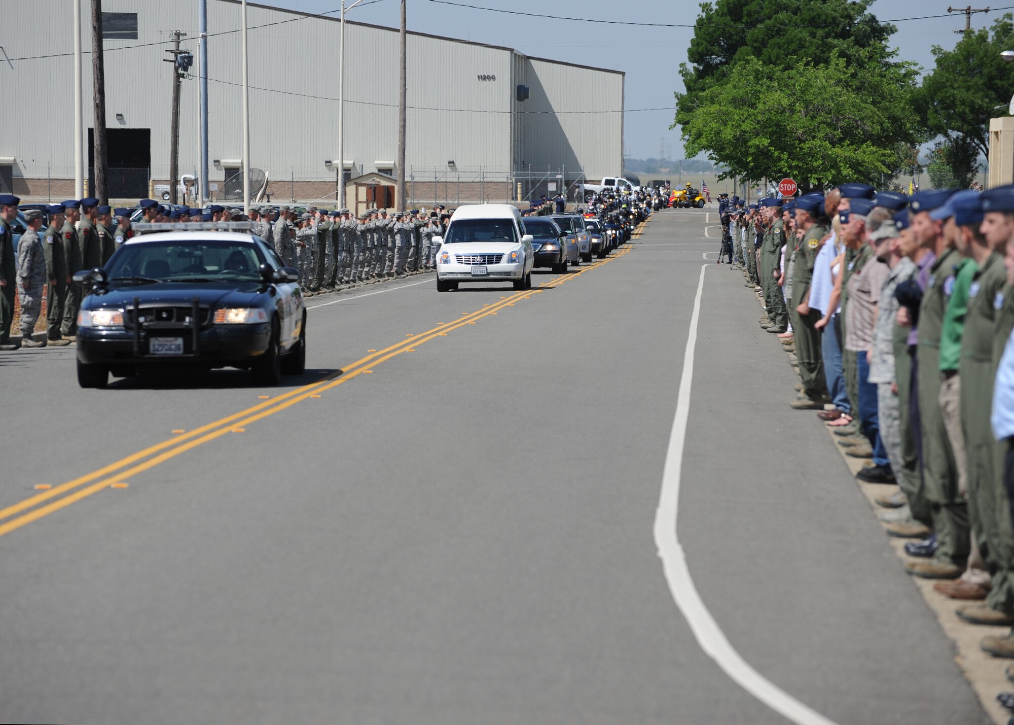 Airmen line the procession route during the dignified transfer of Staff Sgt. Richard Dickson at Beale Air Force Base Calif., May 10, 2013. Airmen honored Dickson with a final salute. (U.S. Air Force photo by John Schwab/Released)