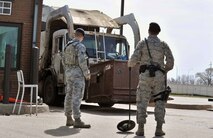MINOT AIR FORCE BASE, N.D. -- Senior Airman Bryan Bartruff and Airman 1st Class Domingo Perez Jr., 5th Security Forces Squadron response force team members, perform vehicle inspections here, May 13. The primary mission of the 5th SFS is to provide 24-hour law enforcement and security services for the 5th Bomb Wing and all tenant units assigned to the base. (U.S. Air Force photos/Senior Airman Brittany Y. Auld)