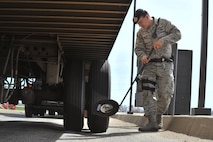 MINOT AIR FORCE BASE, N.D. -- Airman 1st Class Domingo Perez Jr., 5th Security Forces Squadron response force team member, uses a reflective mirror to inspect the undercarriage of a vehicle here, May 13. The primary mission of the 5th SFS is to provide 24-hour law enforcement and security services for the 5th Bomb Wing and all tenant units assigned to the base. (U.S. Air Force photos/Senior Airman Brittany Y. Auld)