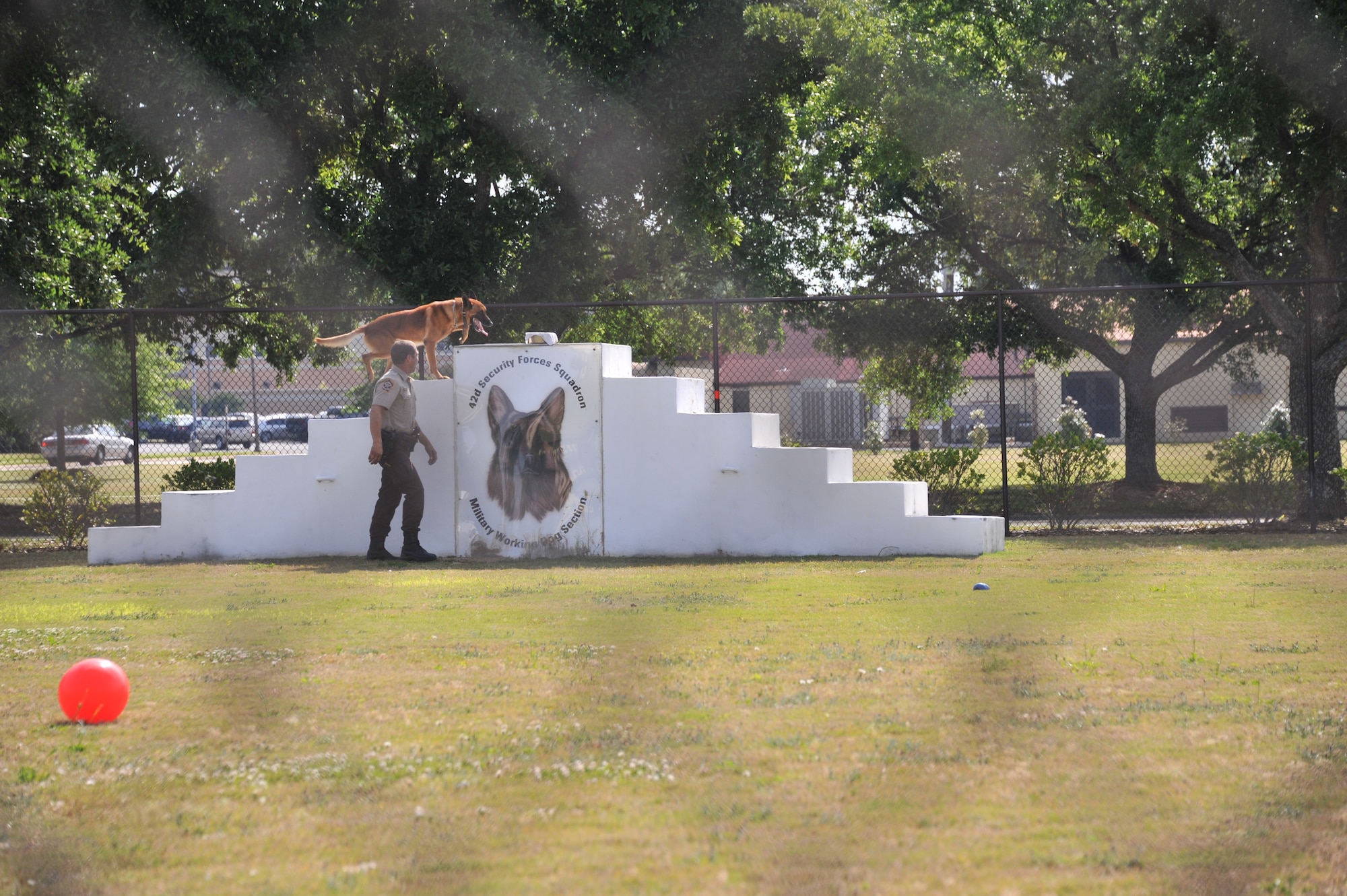 A Montgomery County police officer goes through the K-9 competition May 16, here, as part of Police Week activities. The 42nd Security Forces Squadron Military Working Dogs hosted Montgomery County Police Department, Alabama Schutzhund Club and Montgomery PD in timed detection, tactical obedience course as well as aggression and obedience demonstration. (U.S. Air Force photo by Master Sgt. Michael Voss) 