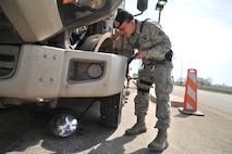 MINOT AIR FORCE BASE, N.D. -- Airman 1st Class Domingo Perez Jr., 5th Security Forces Squadron response force team member, uses a reflective mirror to inspect the undercarriage of a vehicle here, May 13. The primary mission of the 5th SFS is to provide 24-hour law enforcement and security services for the 5th Bomb Wing and all tenant units assigned to the base. (U.S. Air Force photos/Senior Airman Brittany Y. Auld)