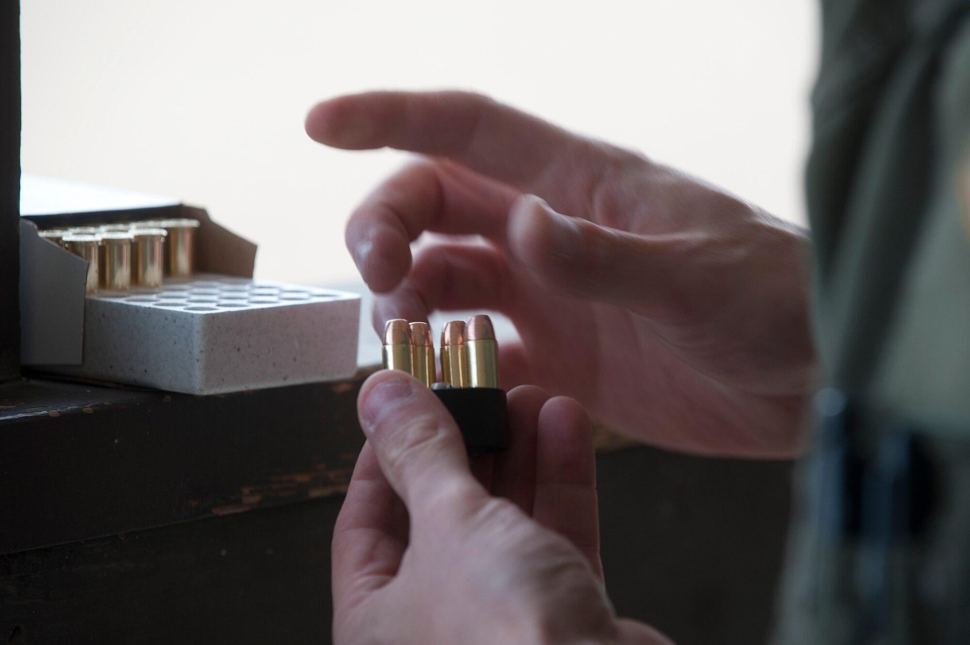 U.S. Air Force Lt. Col. Christopher Bergstol, 366th Operations Group deputy commander, loads ammunition into his clip, May 14, 2013, at Mountain Home Air Force Base, Idaho. Lt Col. Bergstol was one of many competitors that entered the Security Forces Sportsman Challenge. (U.S. Air Force photo by Airman 1st Class Brittany A. Chase/Released)