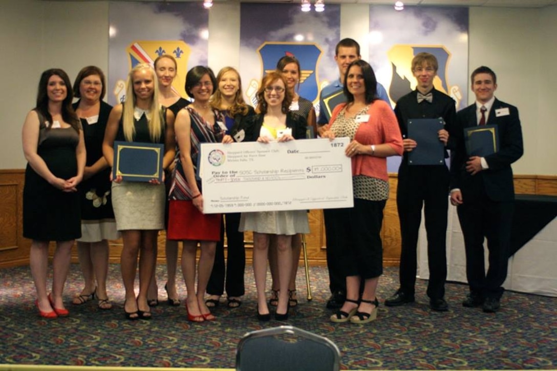 (Left to right)  Leigh Weidman, Sheppard Officers' Spouses Club president and Trish Berube, SOSC 2nd vice president, stand with scholarship recipients Abigail Skipworth, Lisa Prakash (mother of Sora Prakash), Cassiel Dillard, Megan Tideman, Jessica Byrd, Ashley Sissel, Zack McMurry, Marci Cantrell (mother of Brittany Walkingstick), Caleb Brumley and Robert Brumley III during the SOSC's Scholarship Dinner May 11, 2013. The SOSC awarded 11 recipients $37,000 for college scholarships during the dinner at the Sheppard Club. (U.S. Air Force courtesy photo)
