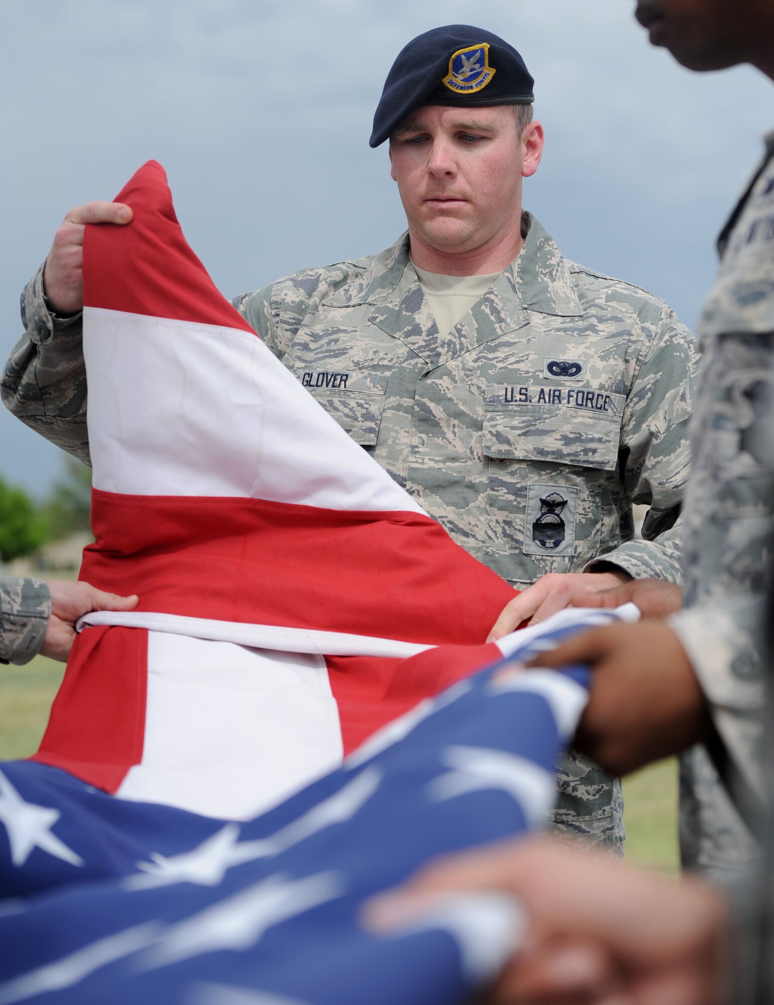 ALTUS AIR FORCE BASE, Okla. – Senior Airman Timothy Glover, 97th Security Forces Squadron patrolman, folds the American Flag during retreat at Wings of Freedom Park, May 15. The 97th SFS led the base in retreat in observance of Peace Officers Memorial Day, which is held annually in honor of law enforcement officers killed or disabled in the line of duty. (U.S. Air Force photo by Airman 1st Class Klynne Pearl Serrano / Released)