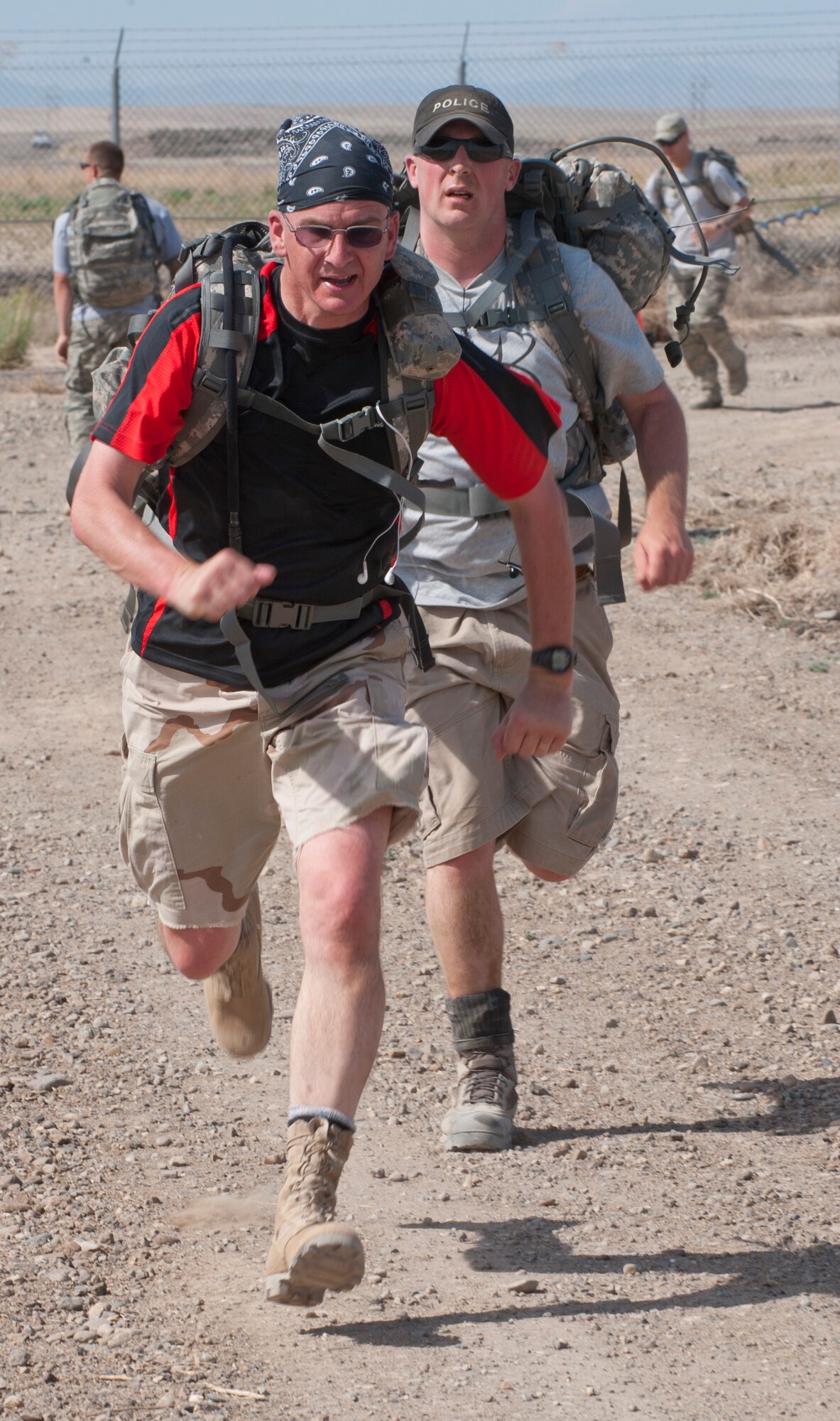 Department of the Air Force Police Officers Gerard Barowitz (left) and Nicholas Guthneck finish up a six mile ruck march during Police Week at Mountain Home Air Force Base, Idaho, May 13, 2013. During Police Week, communities across the nation pay tribute to fallen law enforcement heroes for the sacrifices they made to protect others. (U.S. Air Force photo by Staff Sgt. Roy Lynch/Released)
