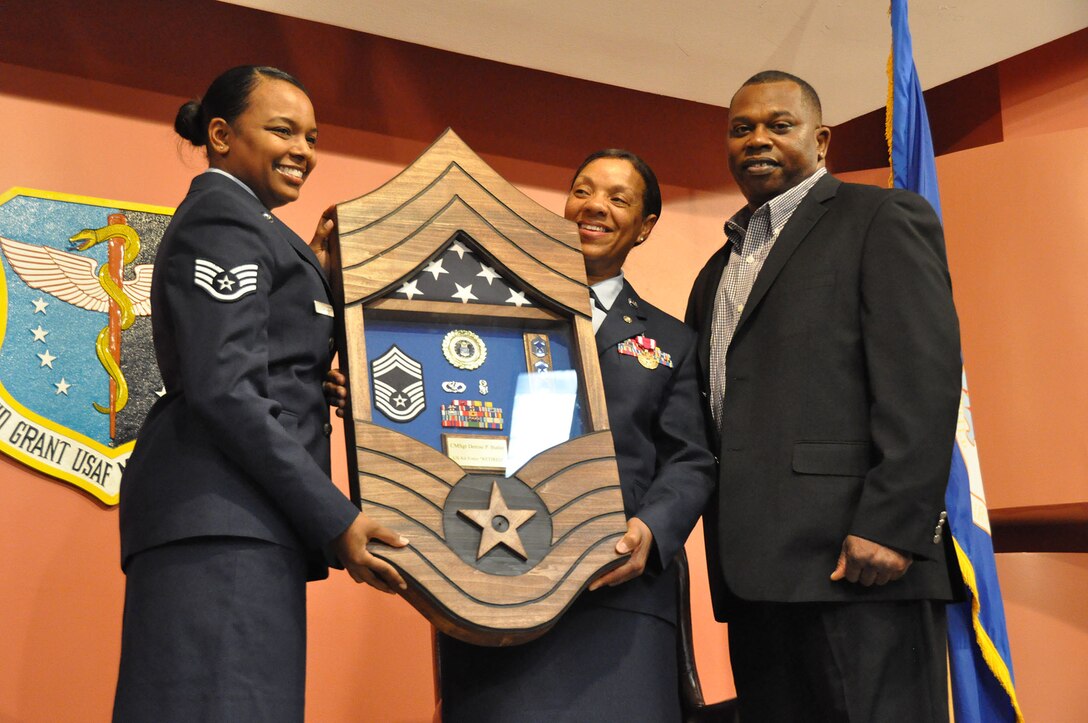 TRAVIS AIR FORCE BASE, Calif. -- After more than 33 years of faithful service to her country, Chief Master Sgt. Denise P. Butler, Superintendent, 349th Aerospace Medicine Squadron, celebrates her many years of service during a ceremony held in her honor at Travis Air Force Base, Calif. on April 7, 2013. (U.S. Air Force photo / Senior Airman Amelia Leonard) 