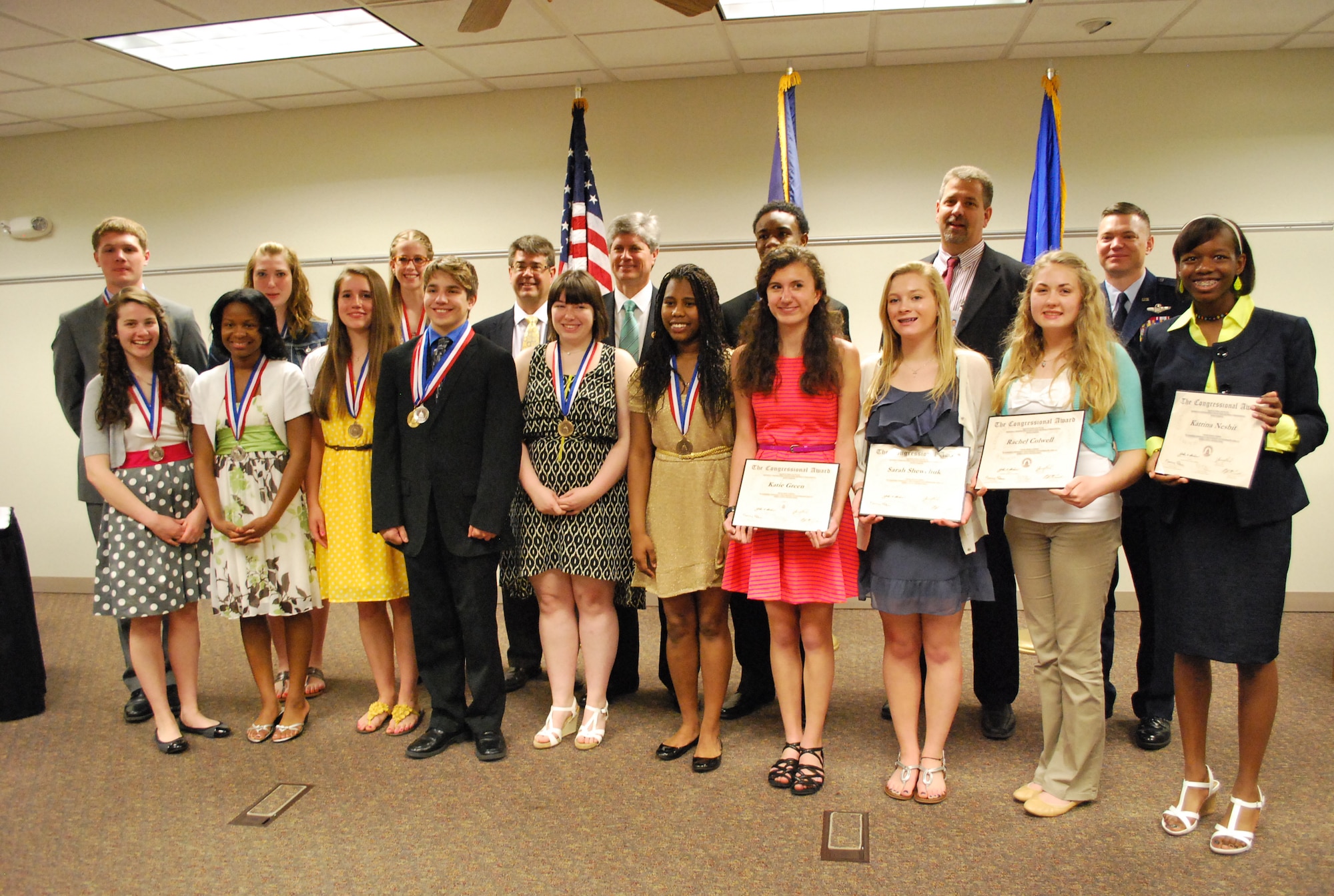 Congressional Award winners pose with Reps. Jeff Fortenberry and Lee Terry, Nebraska congressmen, and Col. John Rauch, 55th Wing commander, following an awards program May 13 at the Bellevue Welcome Center in Bellevue, Neb. Fourteen young adults were presented with medals and certificates, bringing the number of awards won by Bellevue and Offutt youth to 68. (Photo courtesy of Bellevue Public Schools)