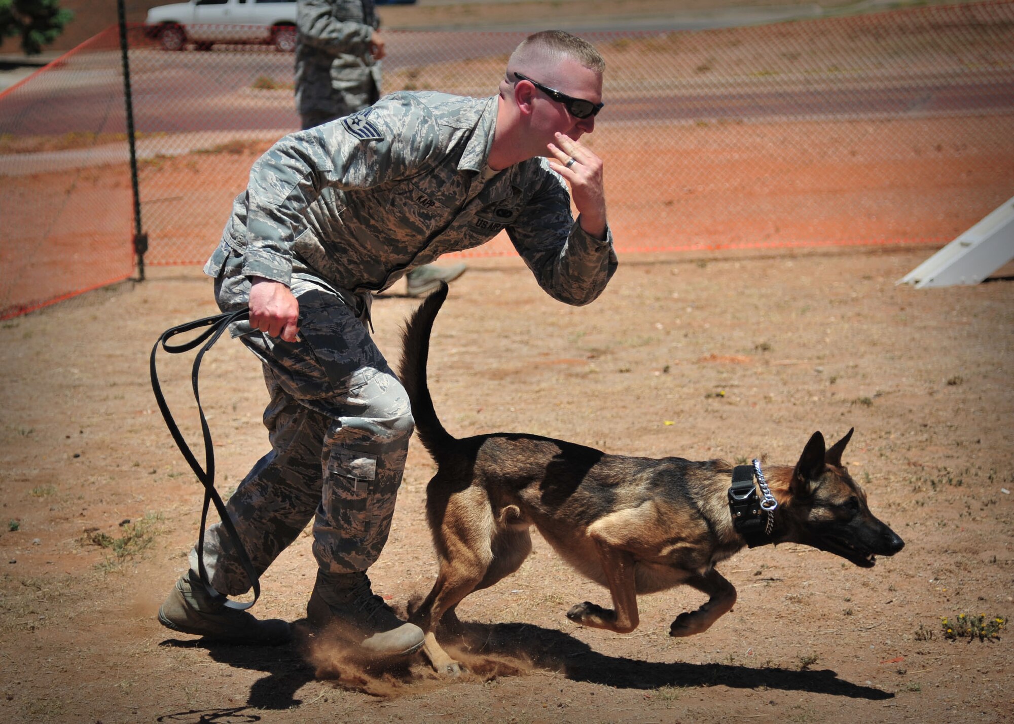 U.S. Air Force Staff Sgt. Curtis Kapp, 27th Special Operations Security Forces Squadron Military Working Dog handler, gives verbal commands and rreleases a K-9 unit during a MWD demonstration as part of National Police Week at Cannon Air Force Base, N.M., May 16, 2013. National Police Week is an observance held to honor law enforcement officials for their sacrifices and hard work. (U.S. Air Force photo/Senior Airman Alexxis Pons Abascal)