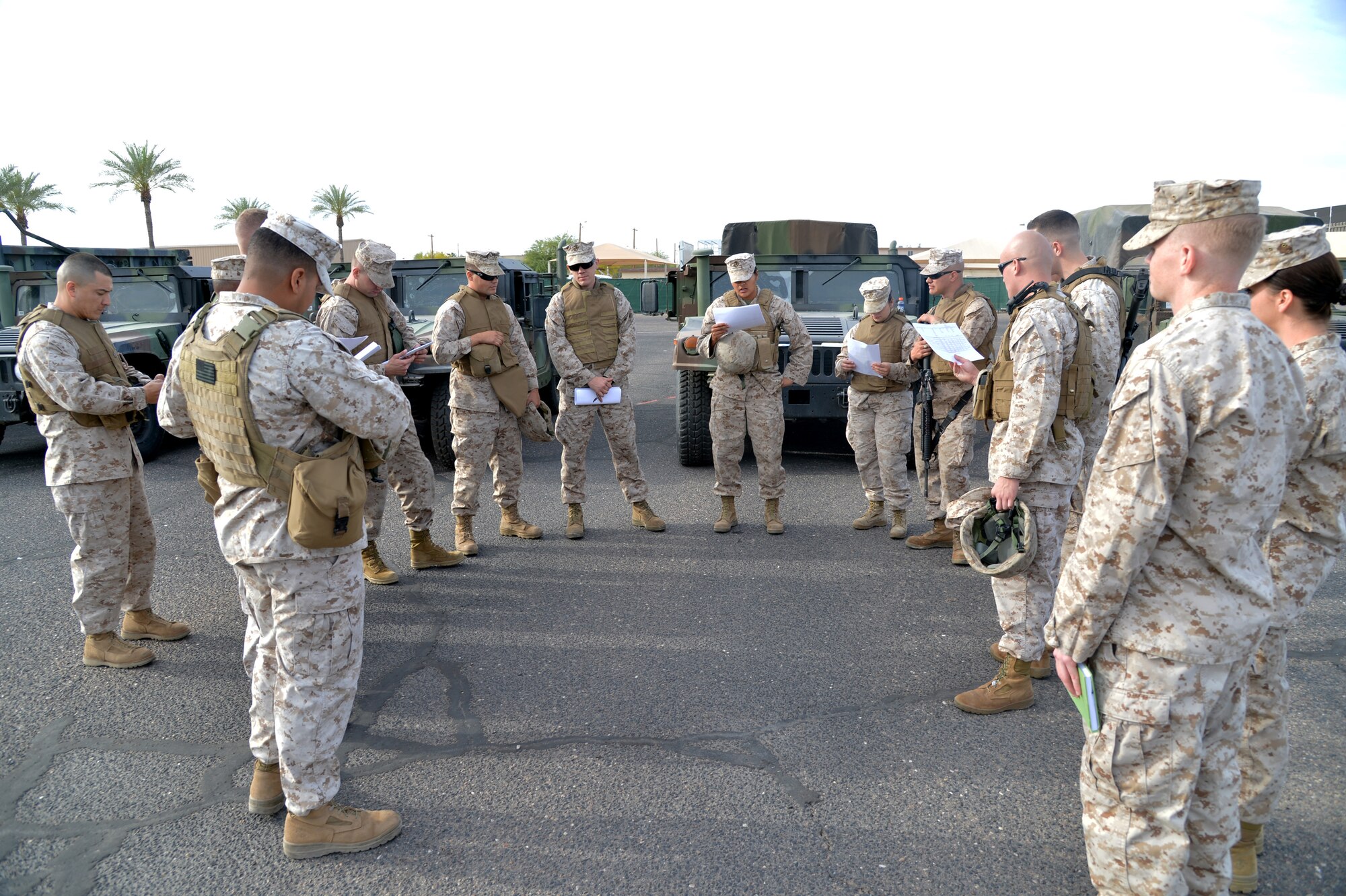 Marines receive a convoy brief before traveling to the firing range at the Arizona Army National Guard’s Florence Military Reservation. The convoy brief is for maintaining safety and communication during travel to Florence and covers contingencies in the event of an emergency. (U.S. Air Force photo/Airman 1st Class James Hensley)